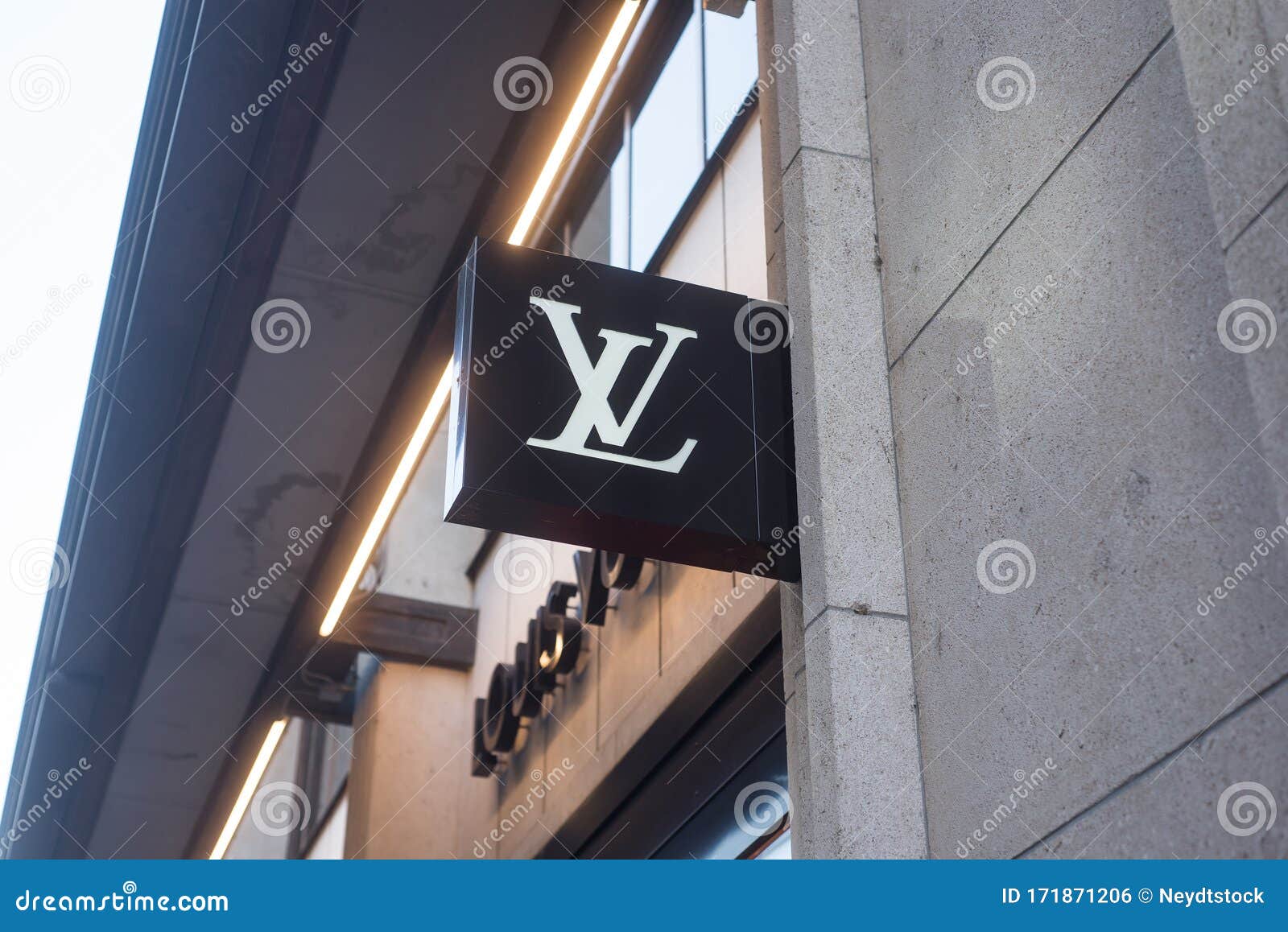 Street Signage Board with Louis Vuitton Logo in the Evening. Blurred  Business District Skyscrapers Background Editorial Image - Image of  evening, banner: 85967980