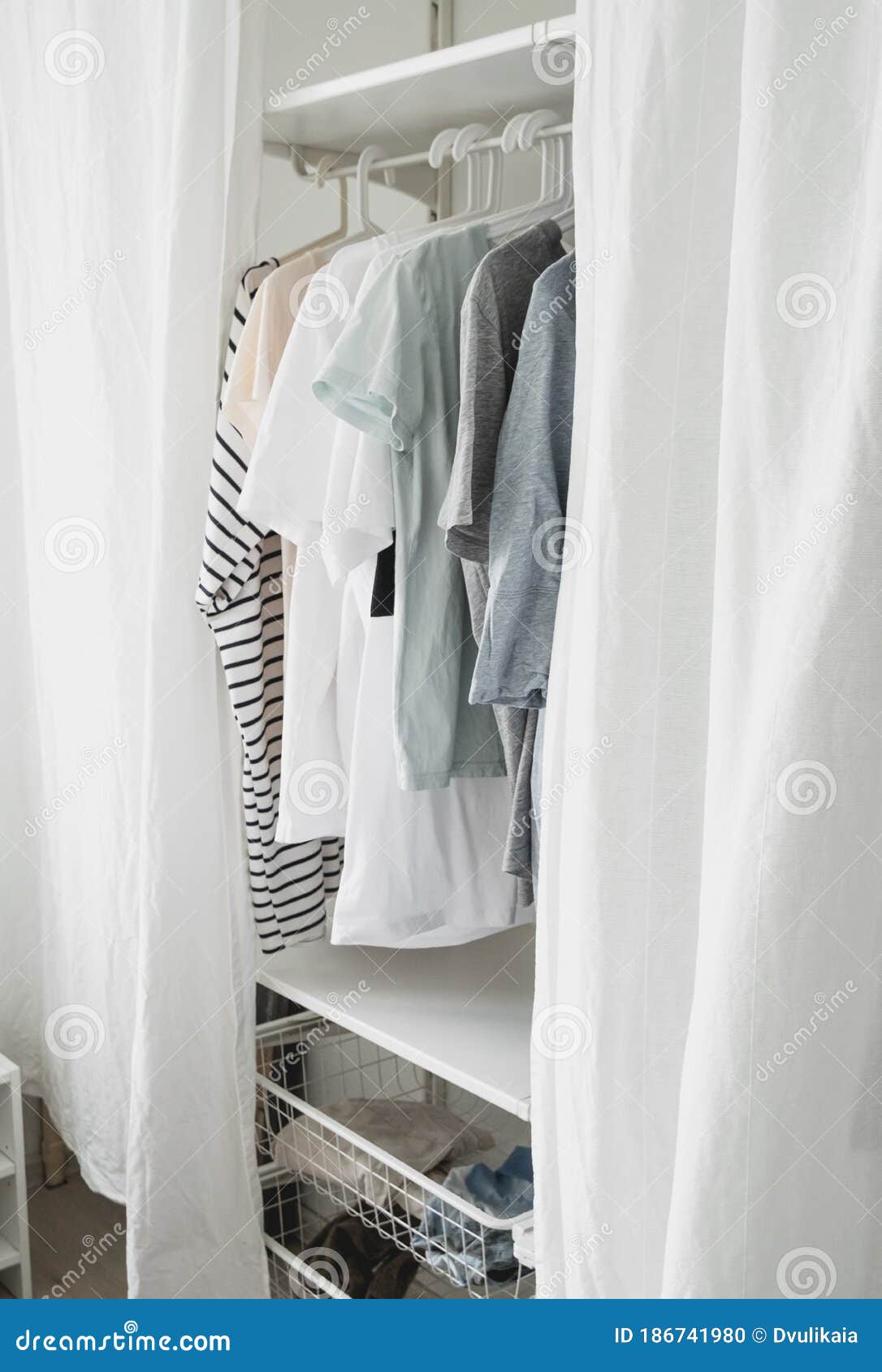 Basic Women Clothes on a Hanger, Open Wardrobe with Textile Curtains