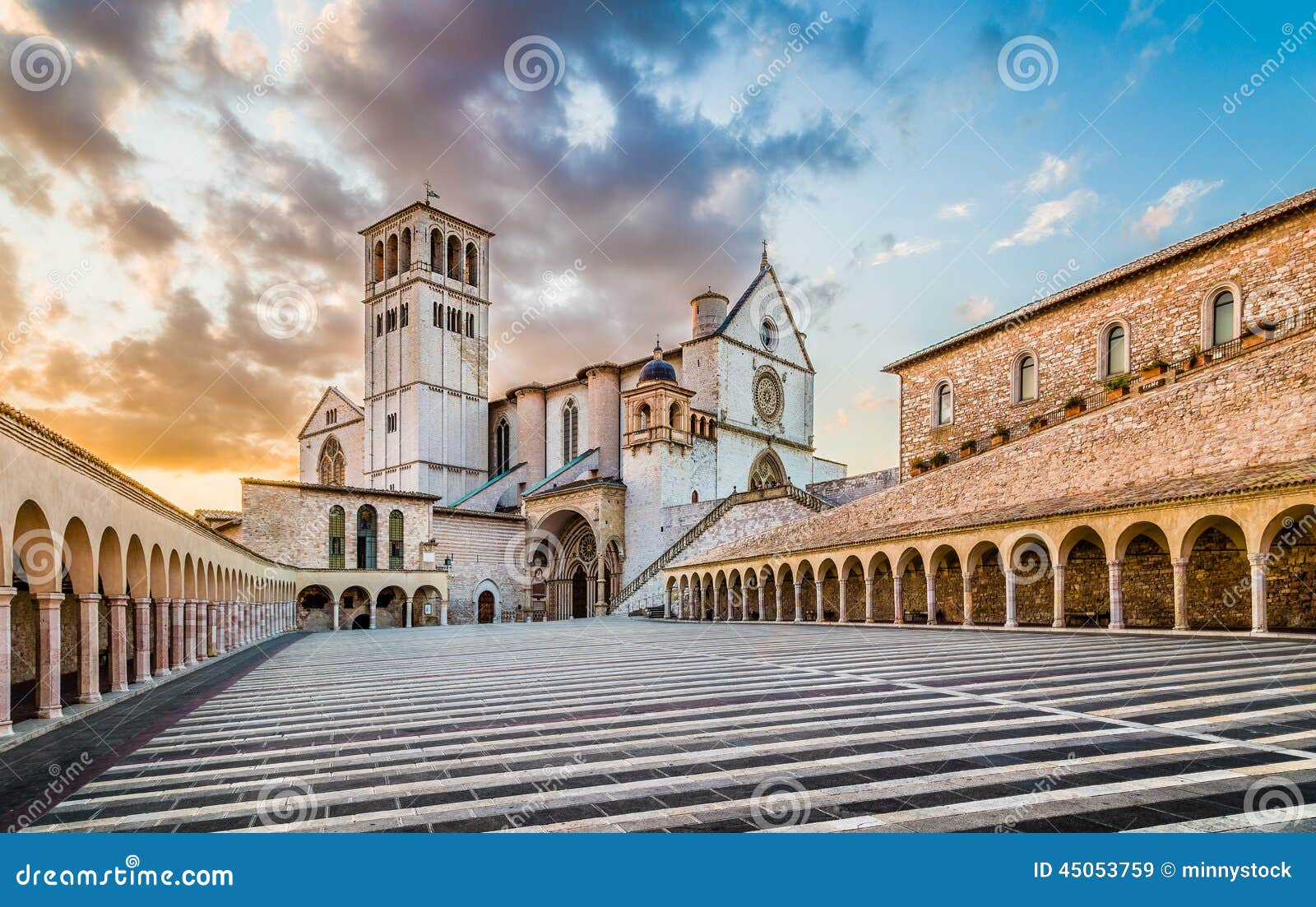 basilica of st. francis of assisi at sunset in assisi, umbria, italy
