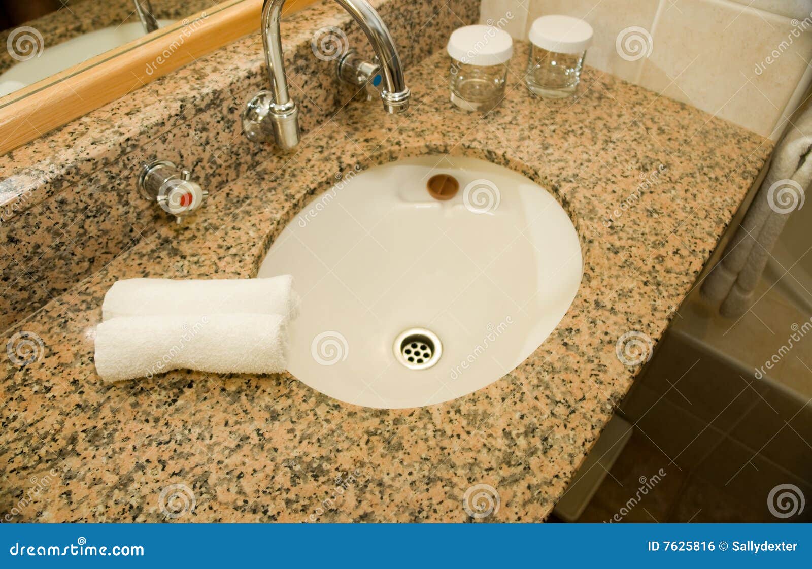 basin and granite vanity in bathroom