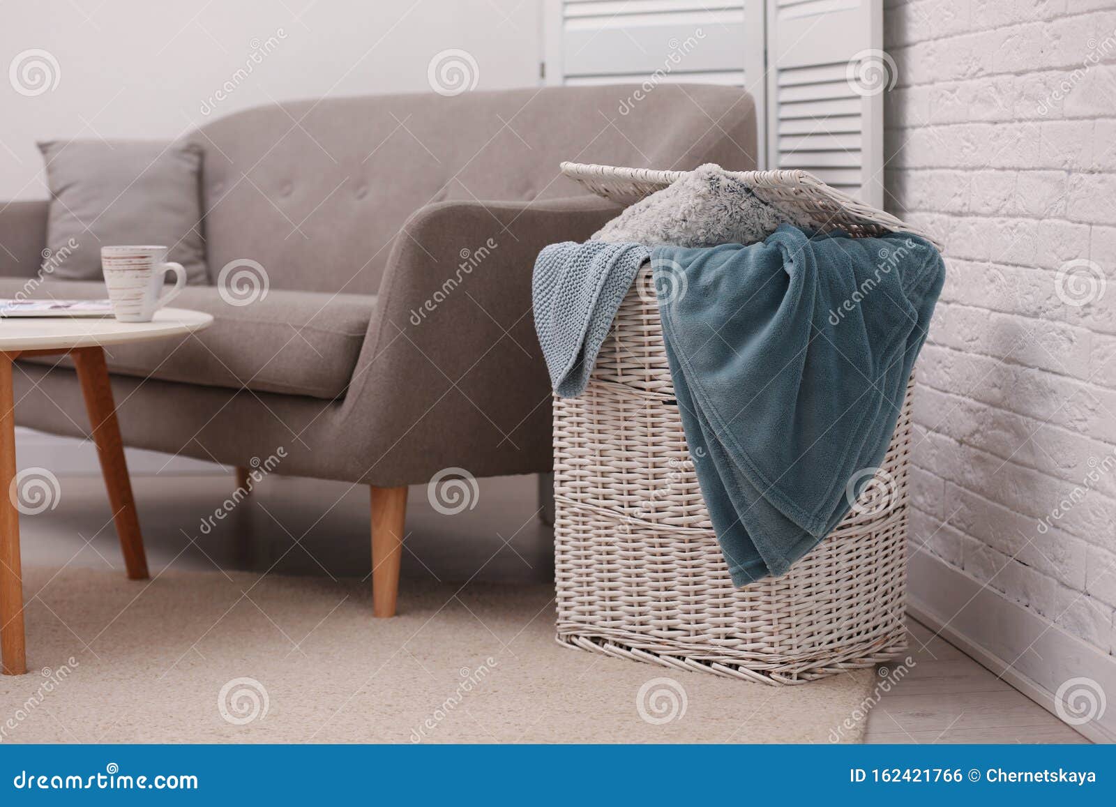 Basket with Blankets and Pillow Near Sofa Stock Photo Image of