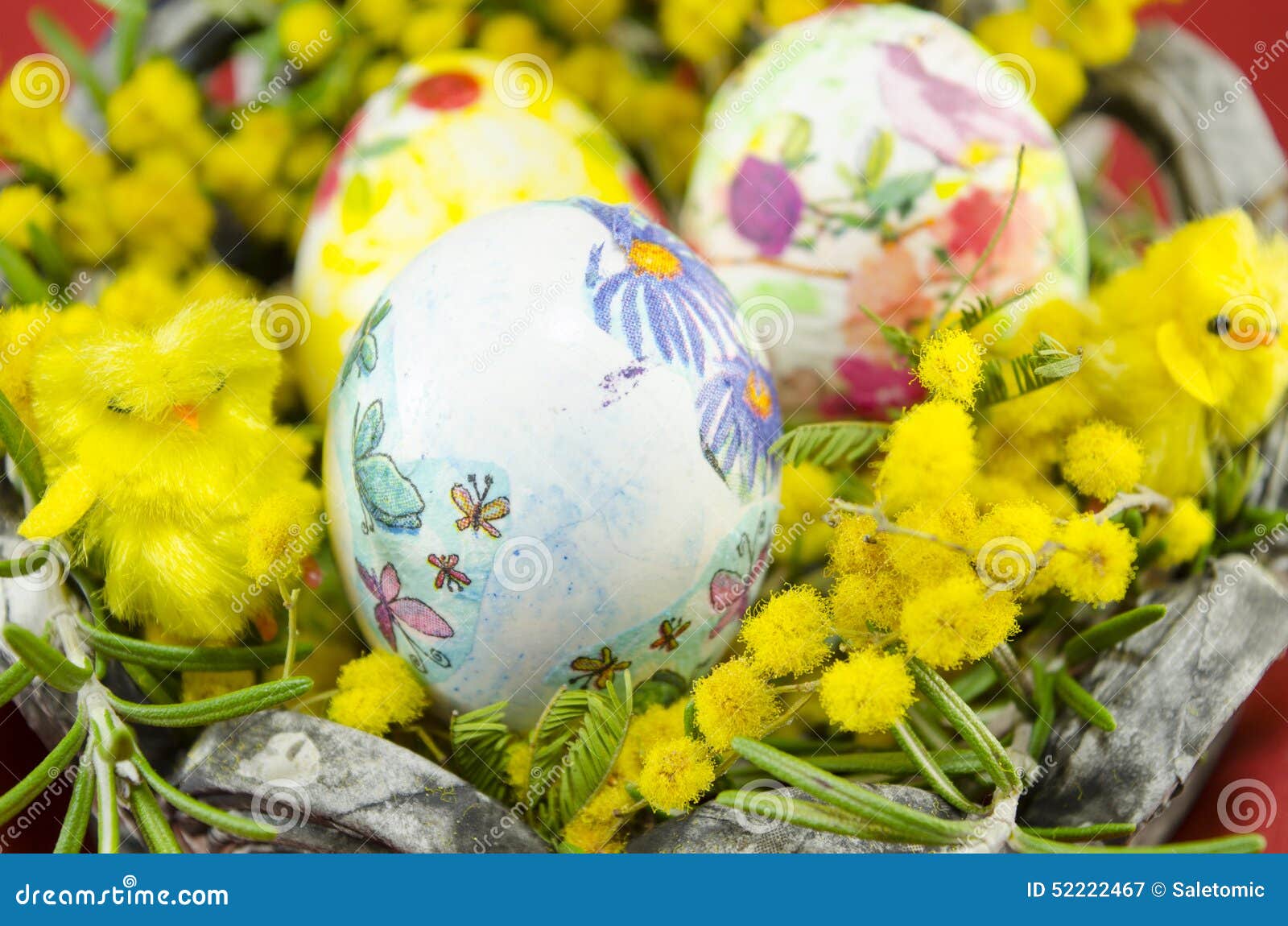 basket full of handcolored easter eggs in decoupage closeup