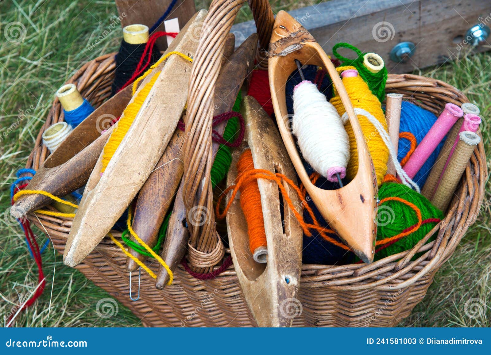 Basket with Spindles and Multicolored Woolen Yarn for Hand Weaving and