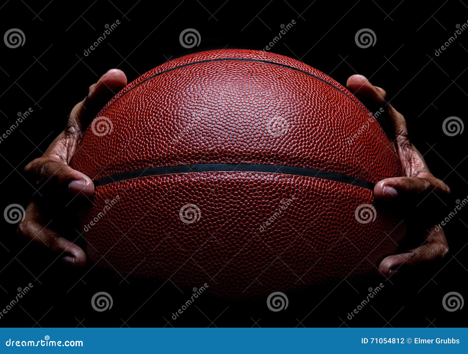 basketball closeup and hand gripping