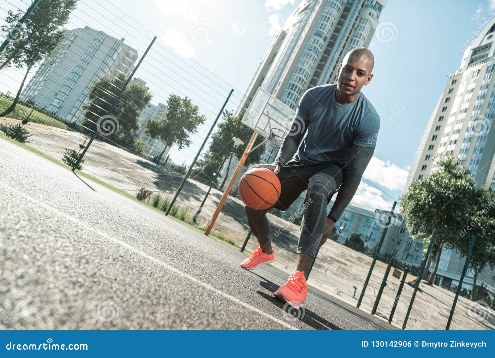 happy active man playing on the basketball court
