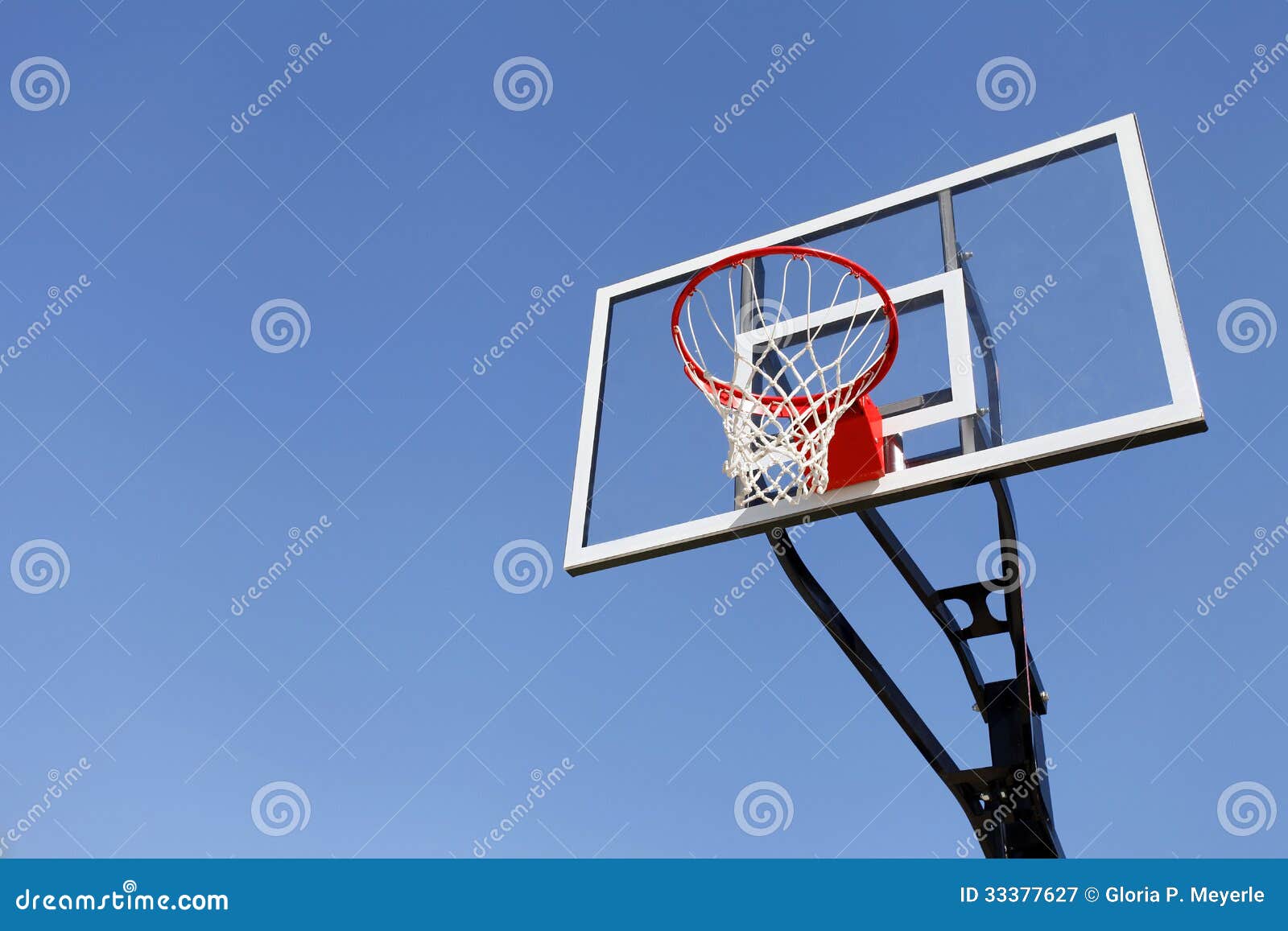 basketball hoop and backboard against blue sky