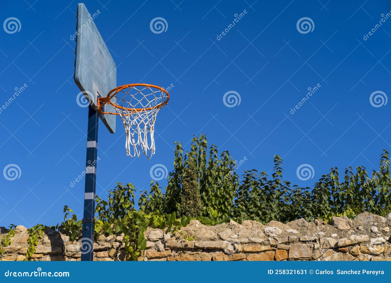 Basketball hoop in a park stock image. Image of blue 258321631