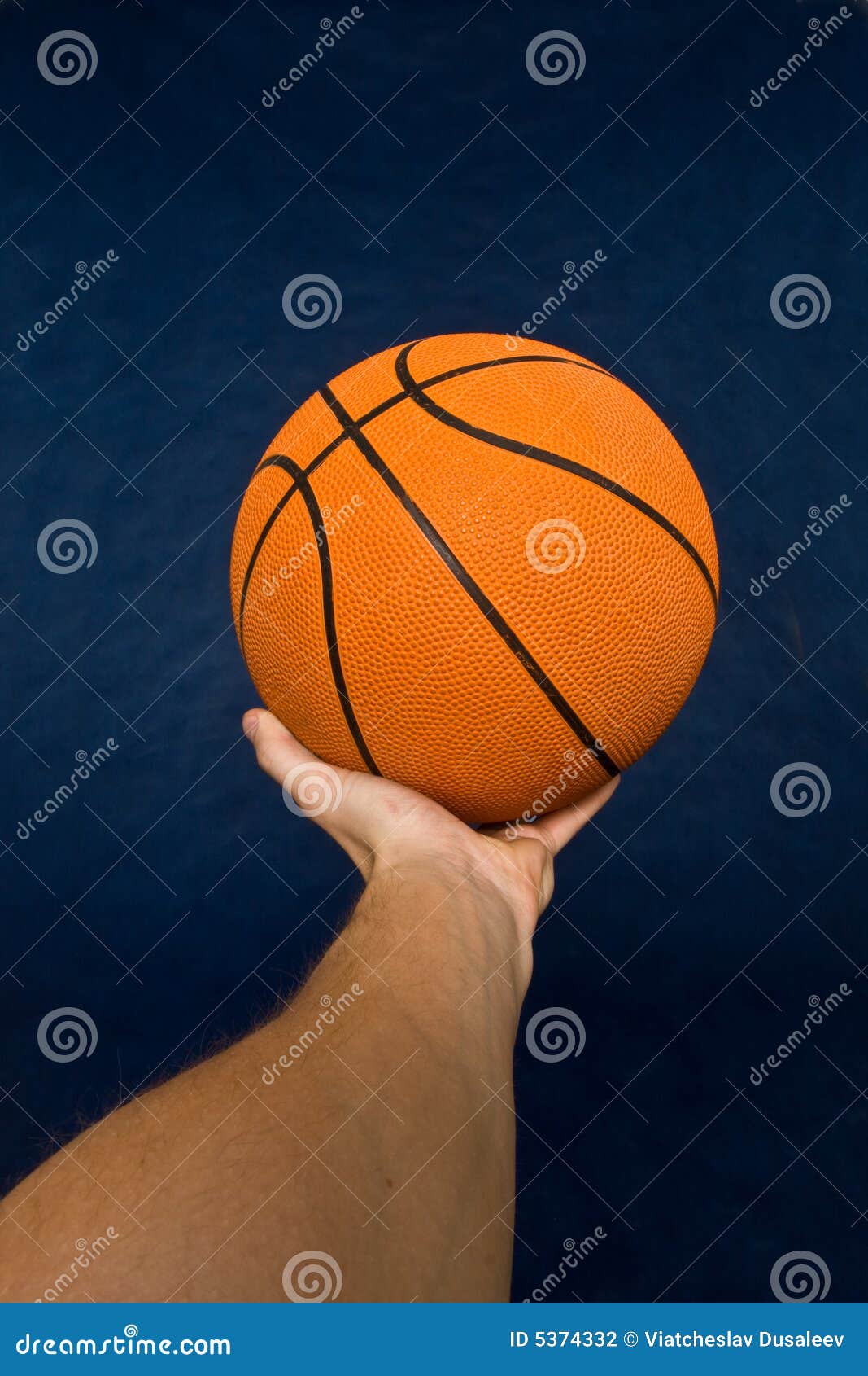 Basketball in mens hand stock photo. Image of orange, sports 5374332