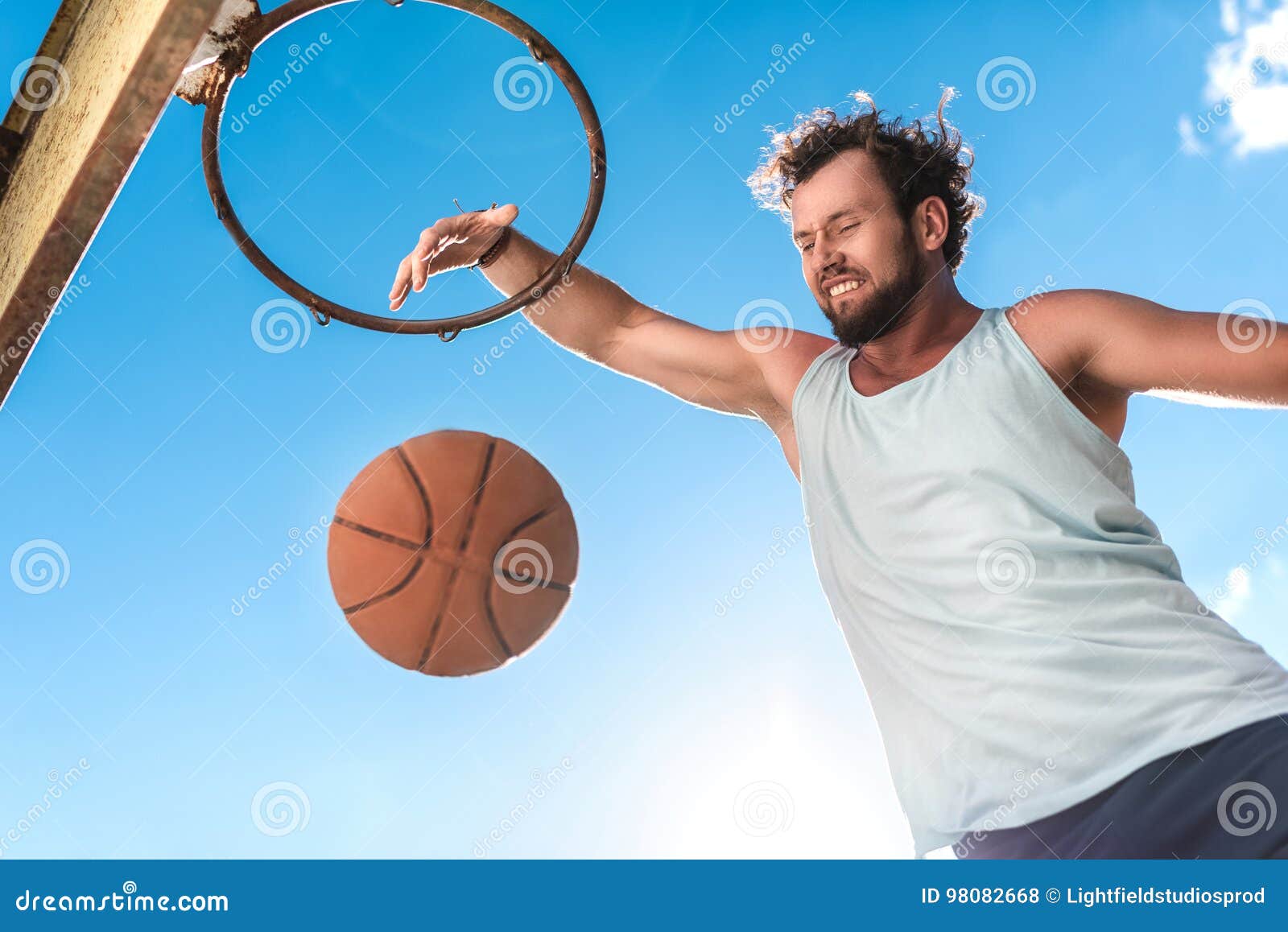 Basketball Player Throwing Ball into Basket Against Blue Sky Stock Photo Image of game