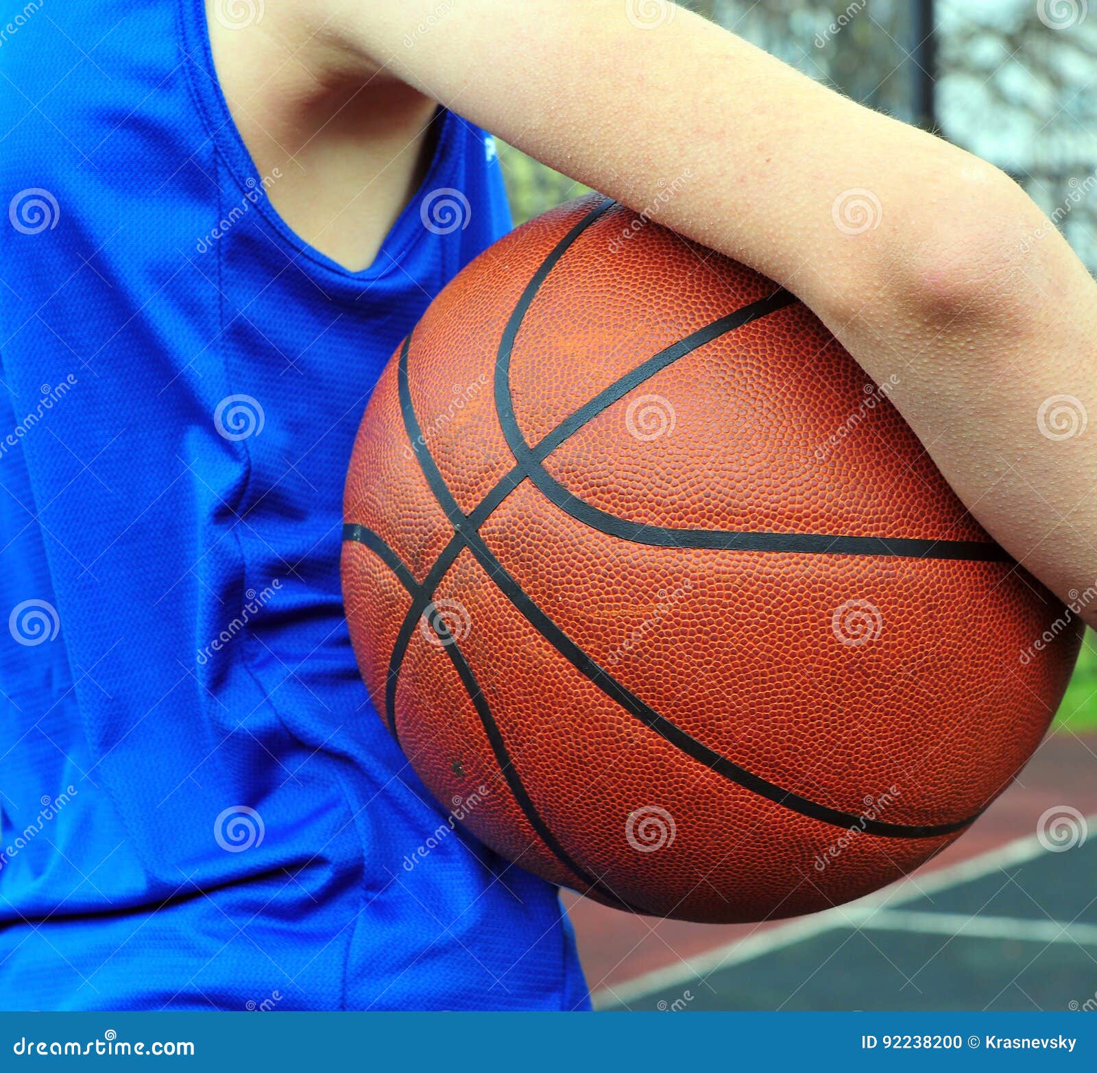 Basketball Player Wearing Blue Uniform with the Ball Stock Photo