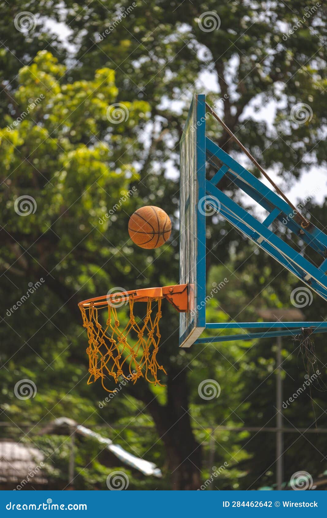 Basketball in the Process of Falling into the Hoop Stock Photo Image