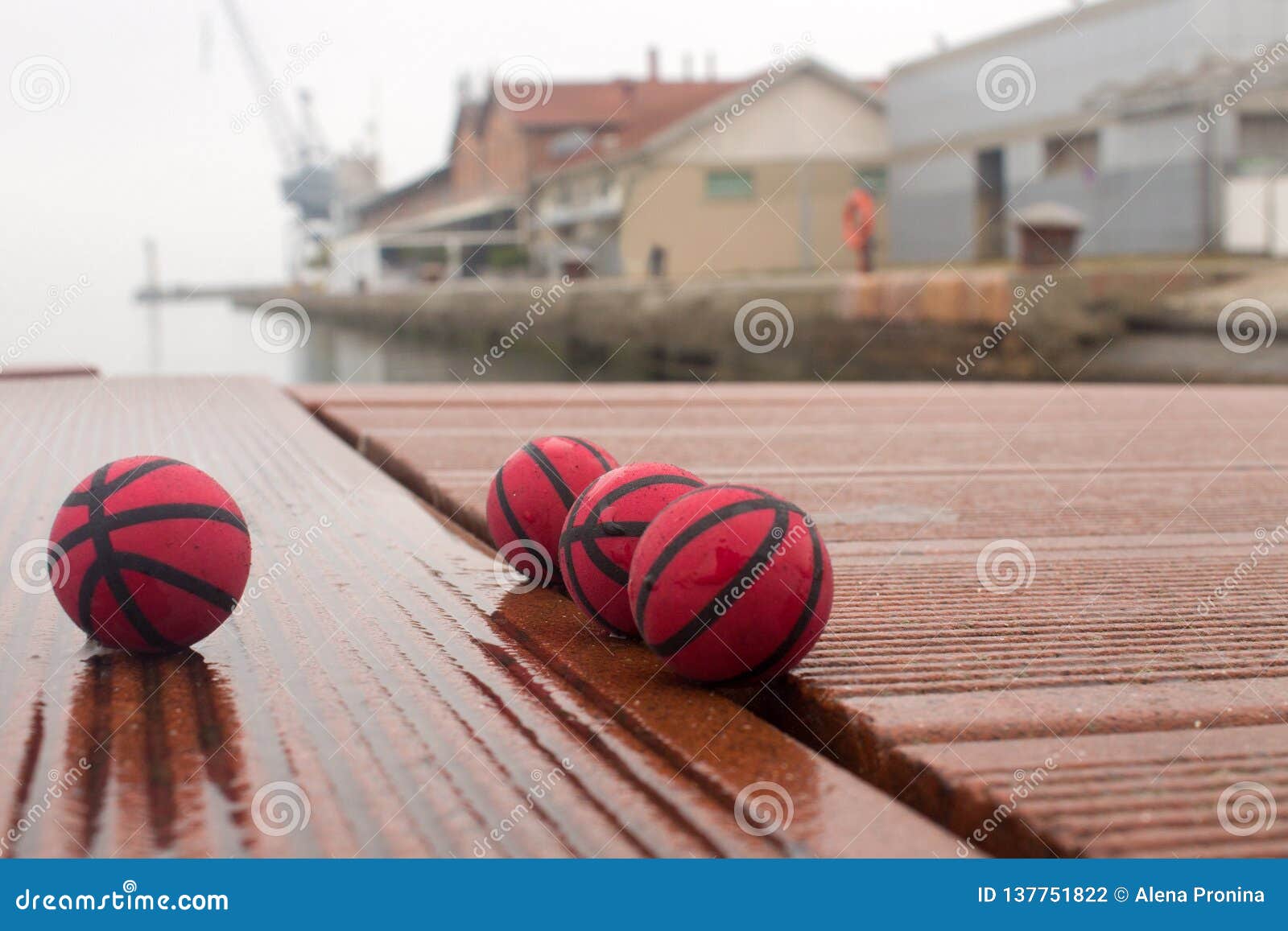 four red basketballs on the panels of the harbor dull day