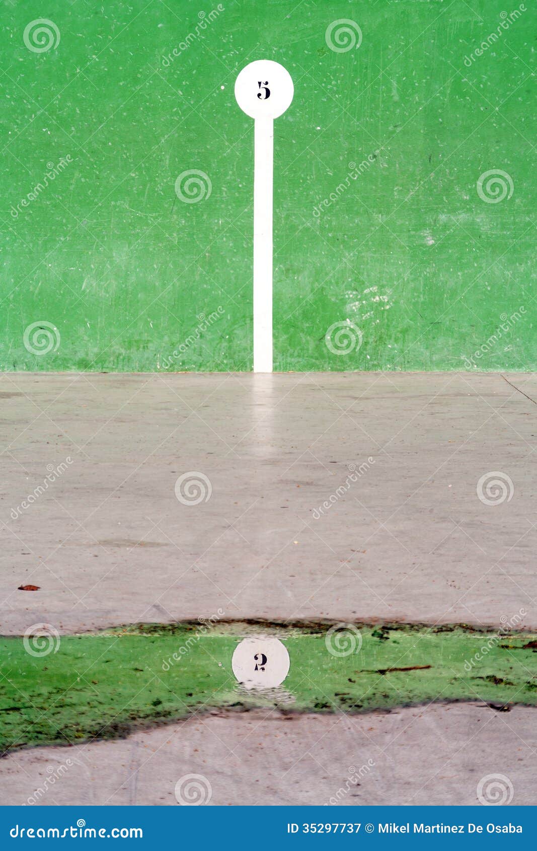 basque pelota court with number reflection on puddle
