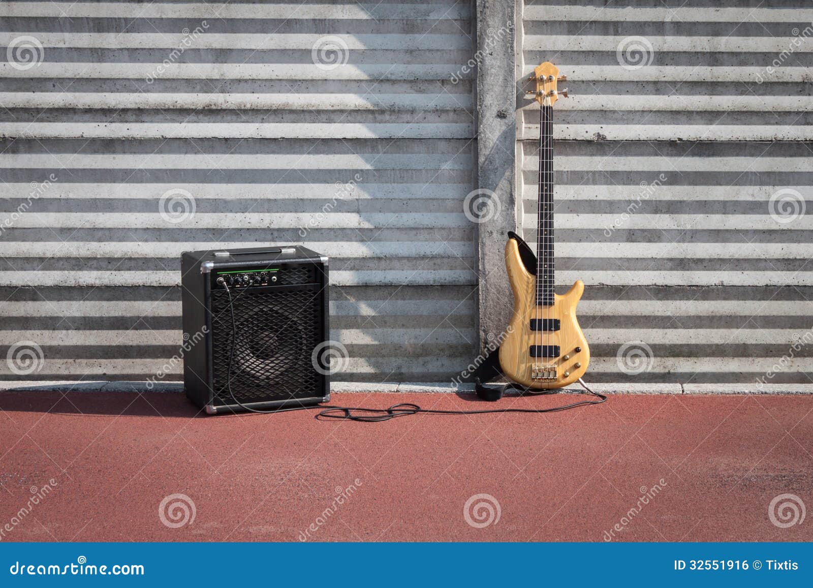 Bass Guitar and Amplifier Against a Wall Stock Photo Image of