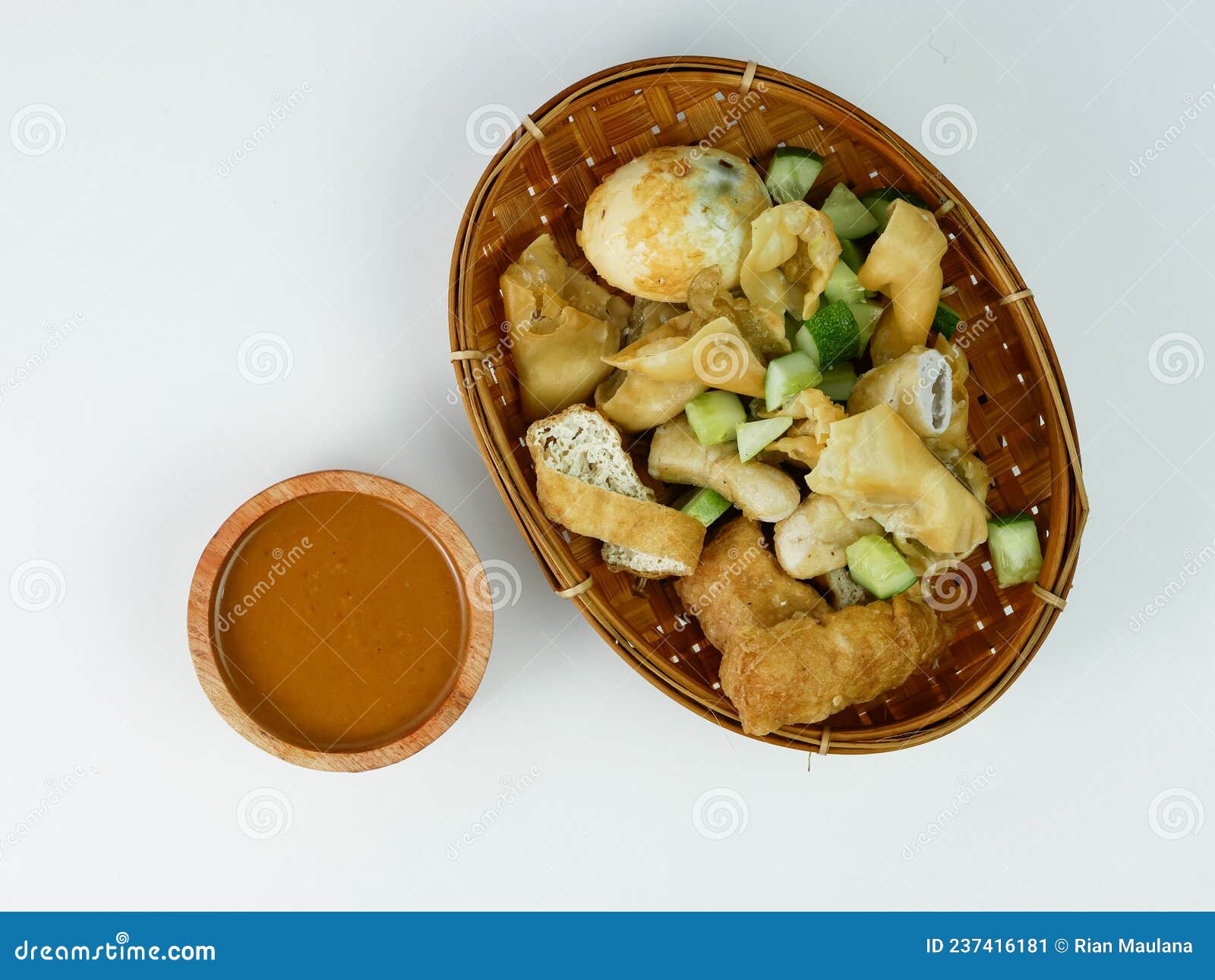 Batagor or Fried Dumplings and Peanut Sauce Isolated on White