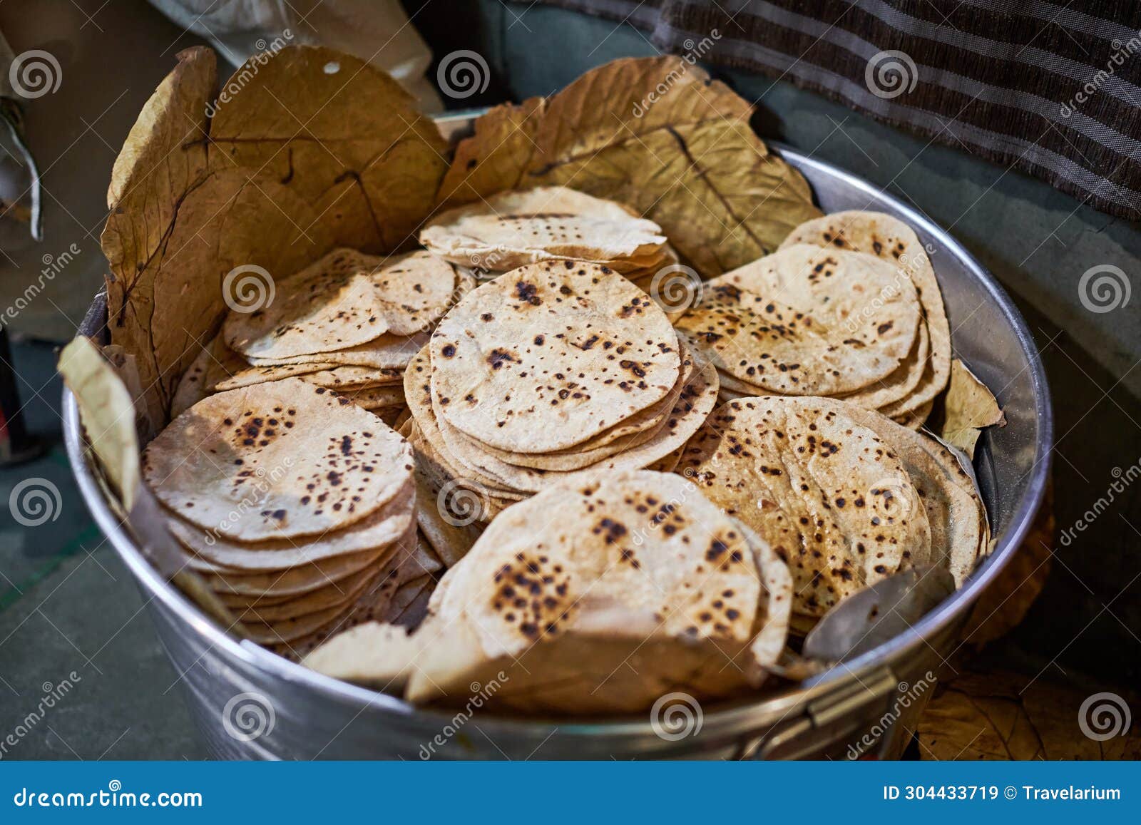 batch of chapati round flatbreads in bucket for langar in sikh gurudwara temple, roti flatbreads