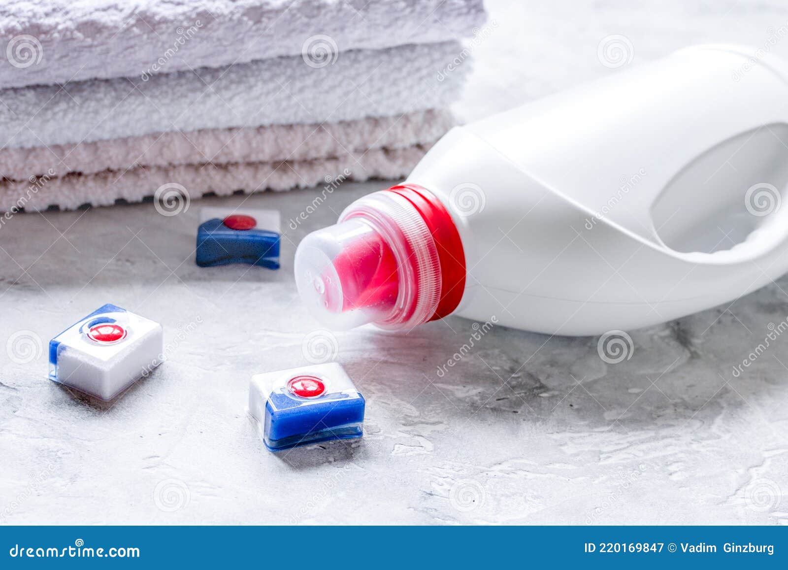Bath Towels Stack with Detergent Bottle in Laundry Light Background