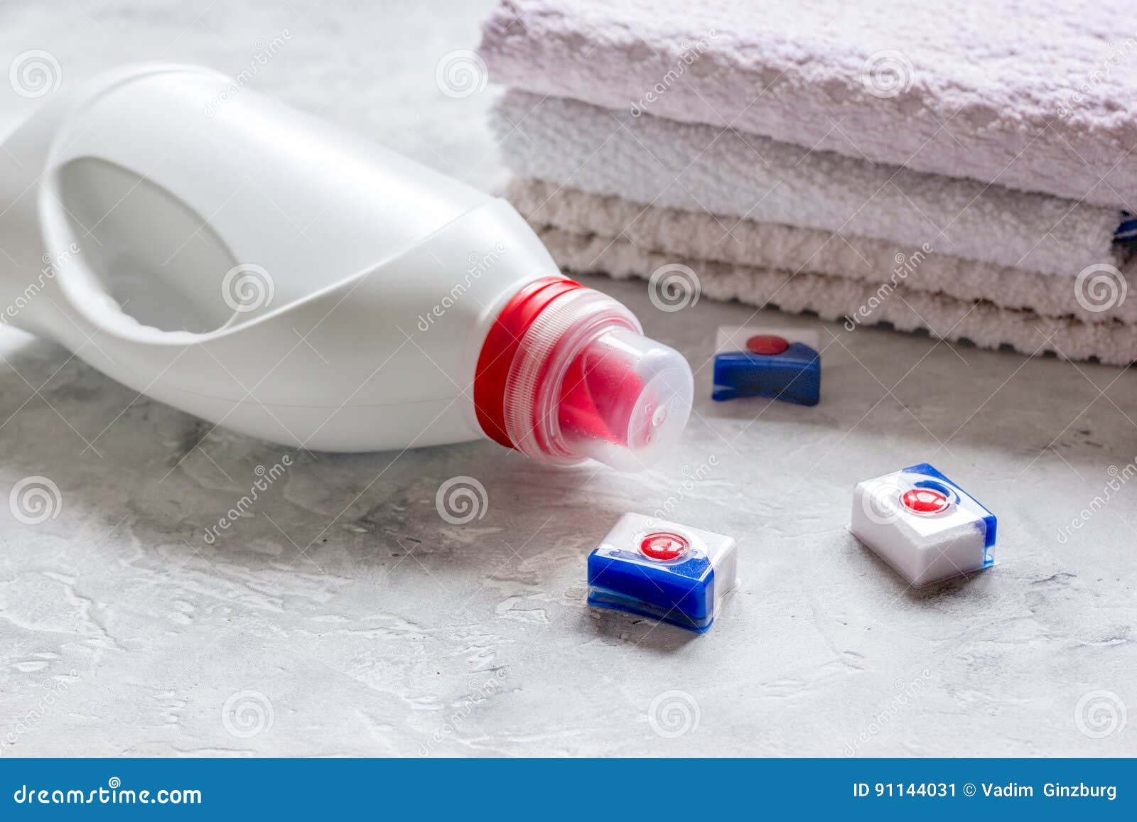 Bath Towels Stack with Detergent Bottle in Laundry Light Background