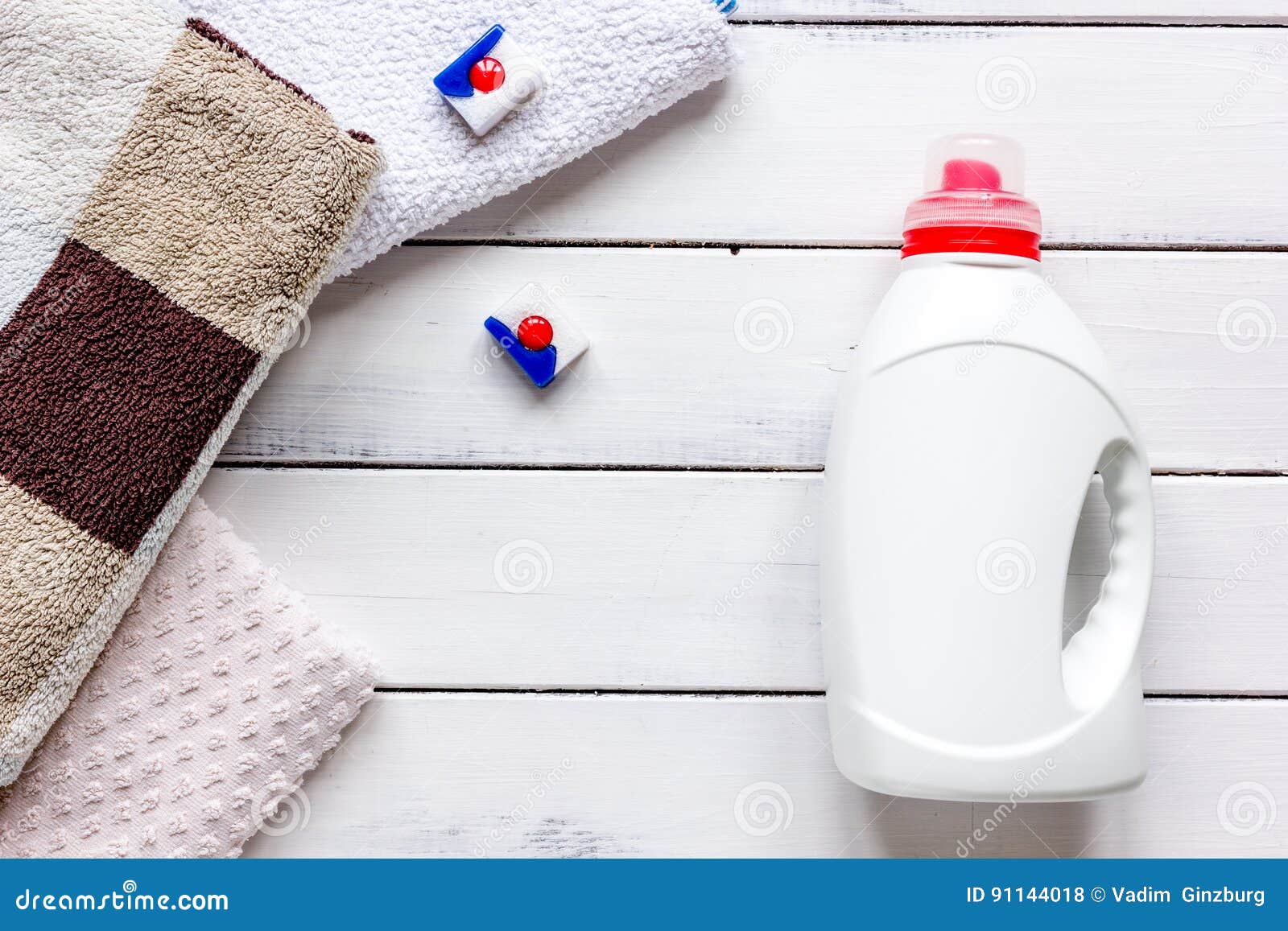 Bath Towels Stack with Detergent Bottle in Laundry Light Background Top