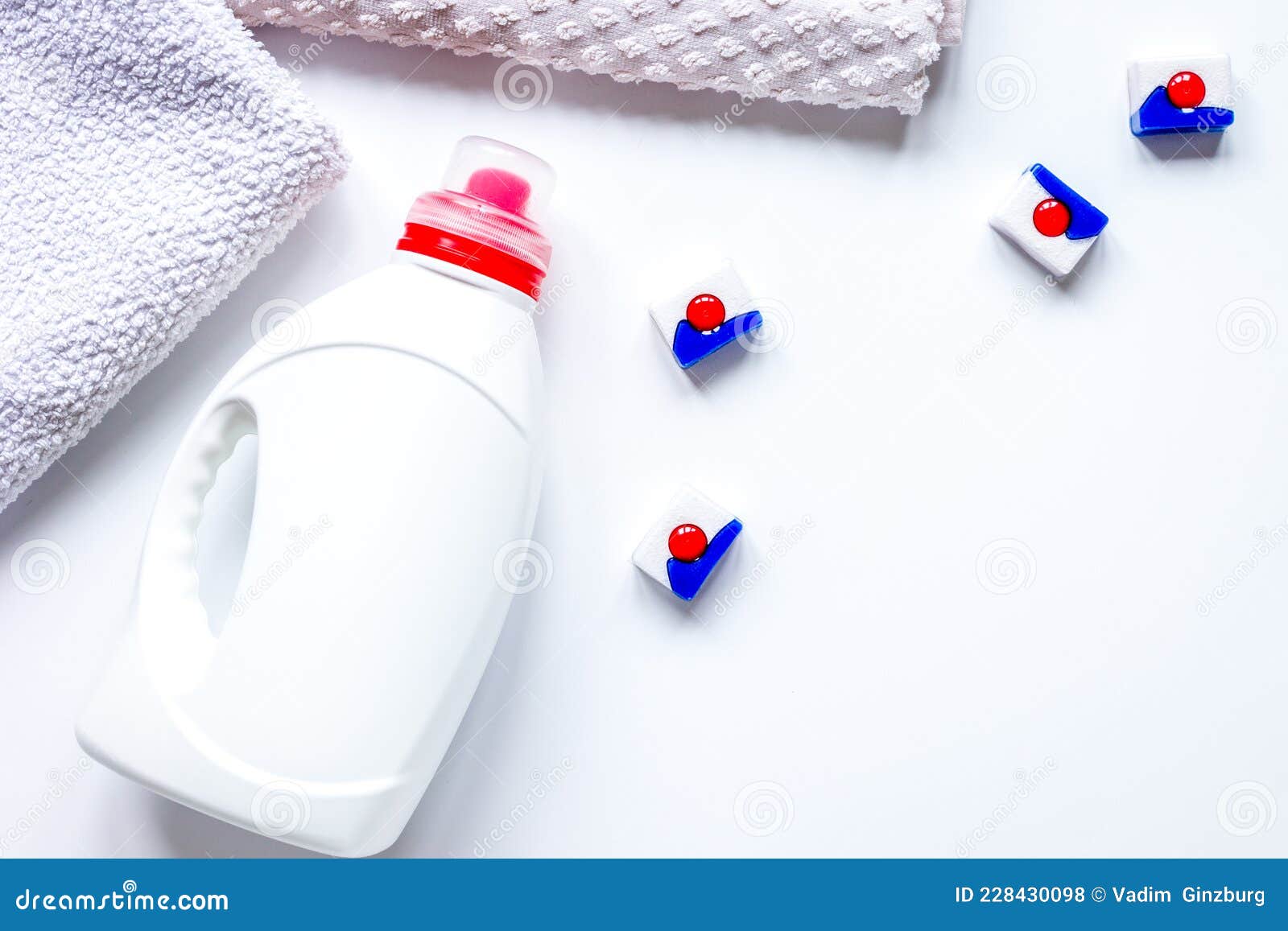 Bath Towels Stack with Detergent Bottle in Laundry Top View Mockup