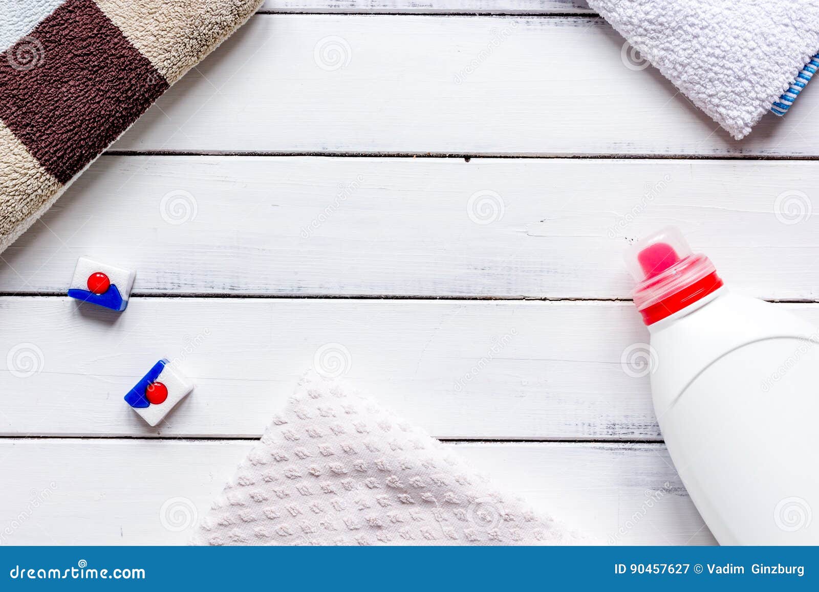 Bath Towels Stack with Detergent Bottle in Laundry Top View Mockup