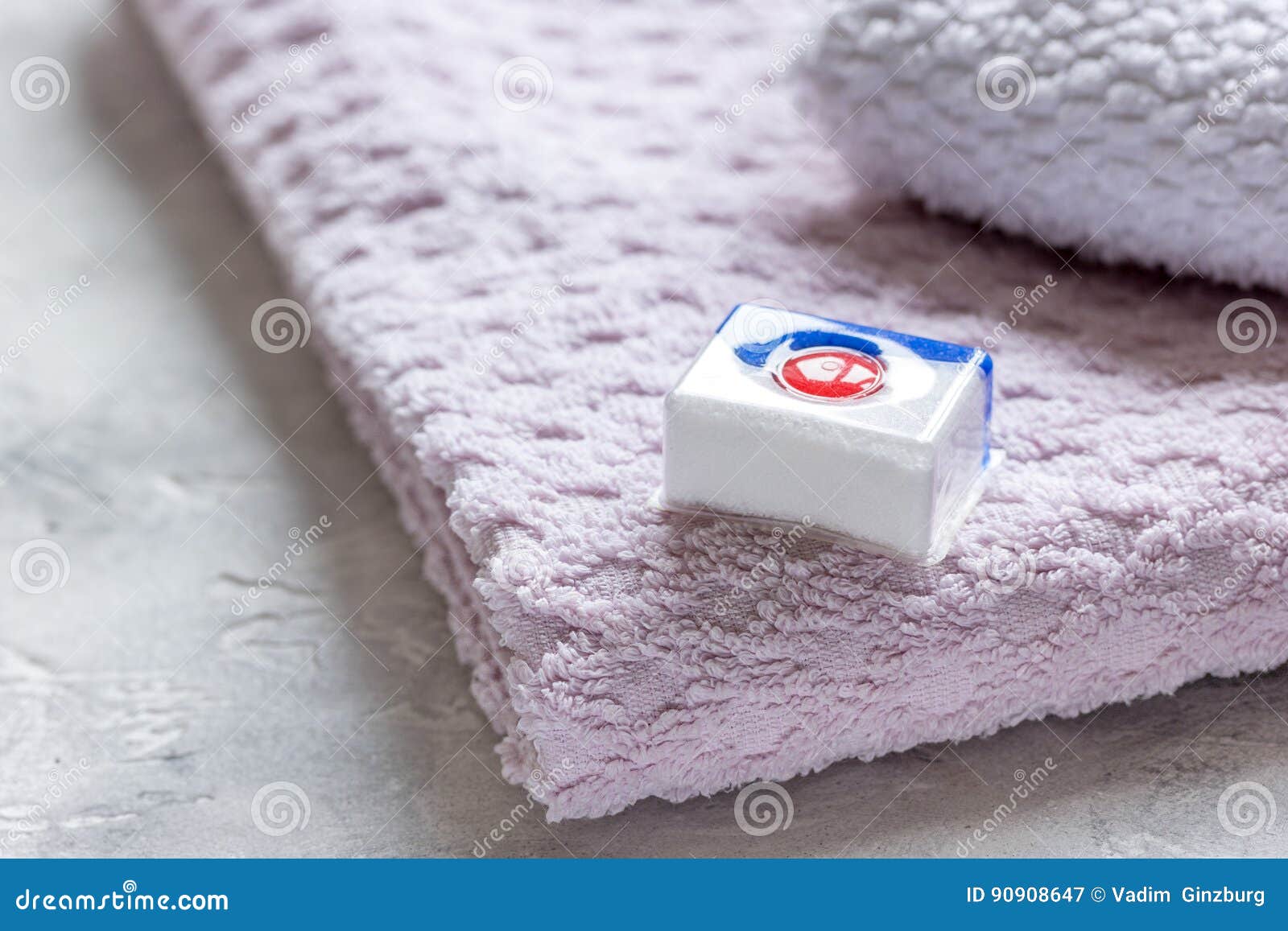 Bath Towels Stack with Detergent in Laundry Light Background Stock