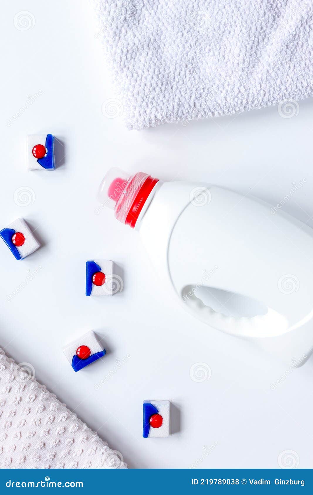 Bath Towels Stack with Detergent Bottle in Laundry Light Background Top