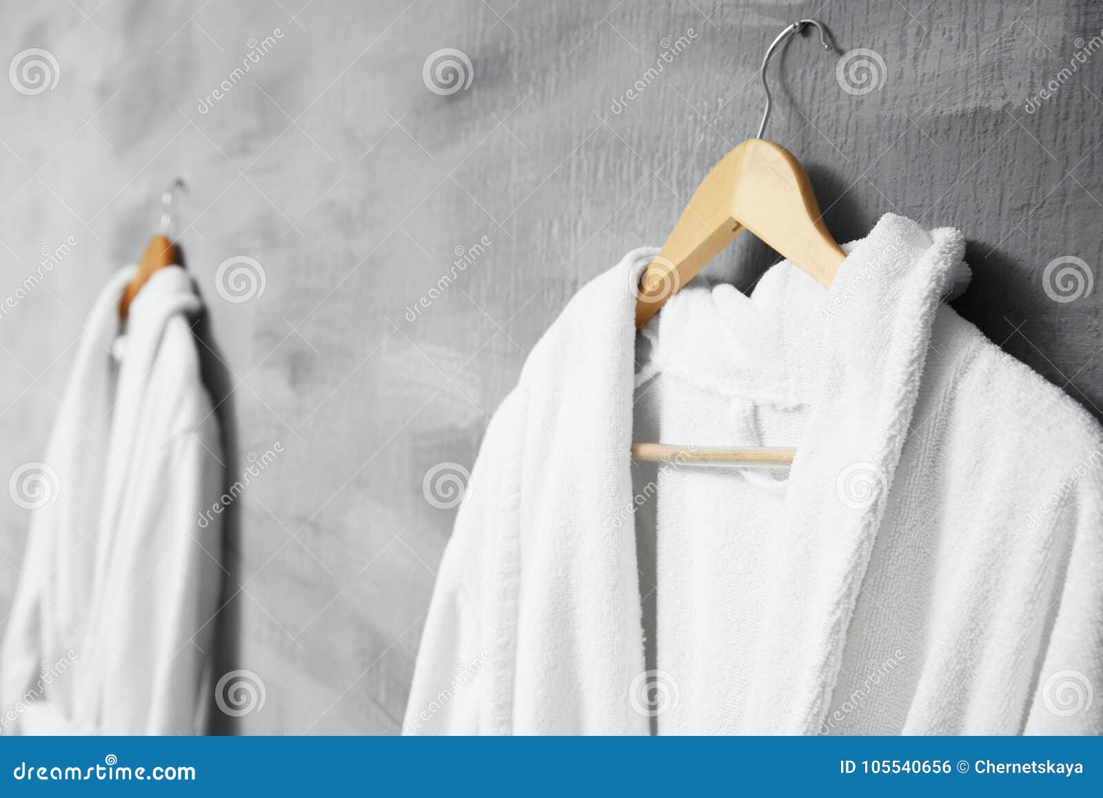 Bathrobe hanging on wall stock photo. Image of comfort 105540656