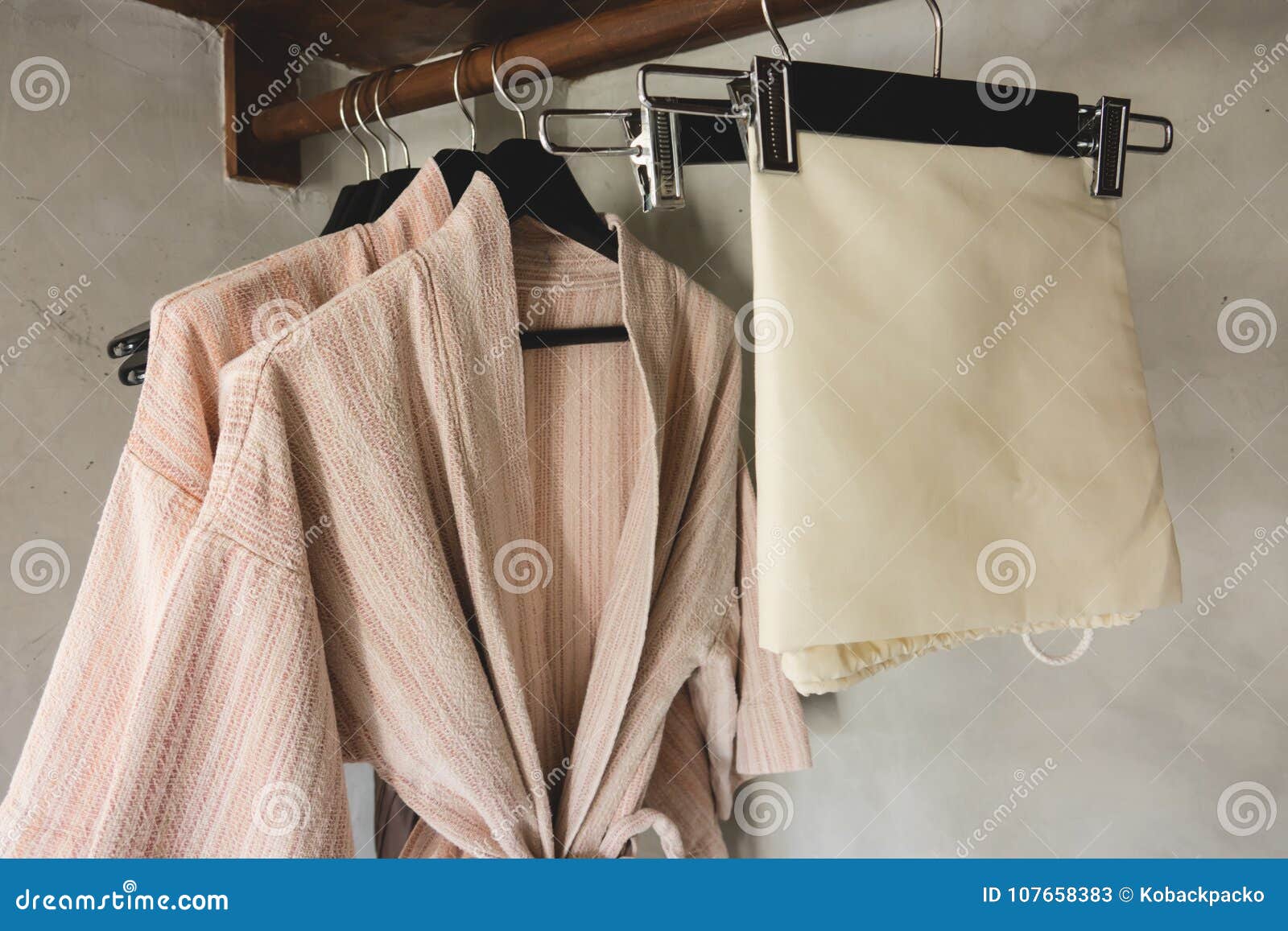 Bathrobe with Wooden Hangers in Wardrobe. Stock Image Image of