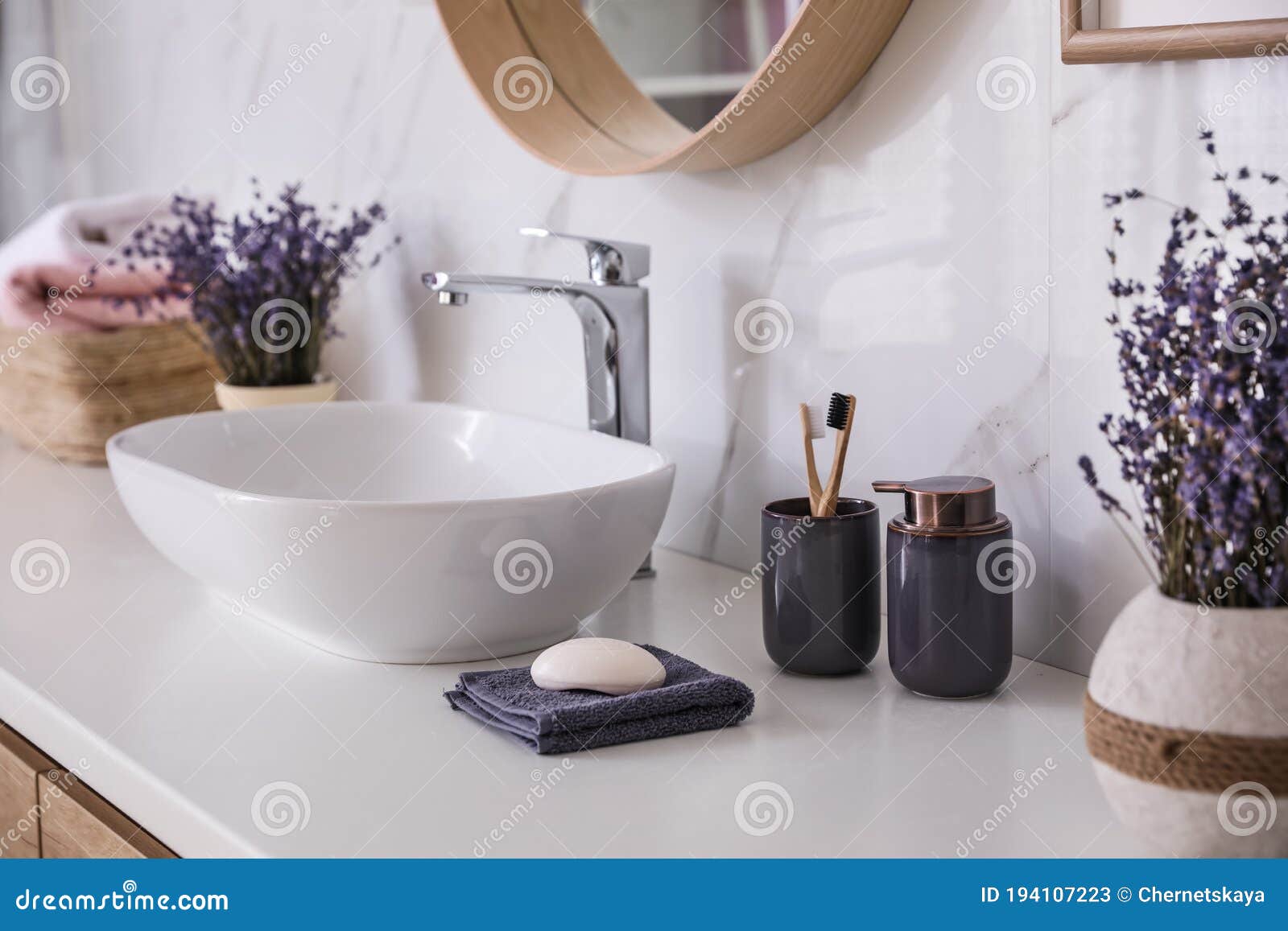 bathroom counter with vessel sink, accessories and flowers. interior