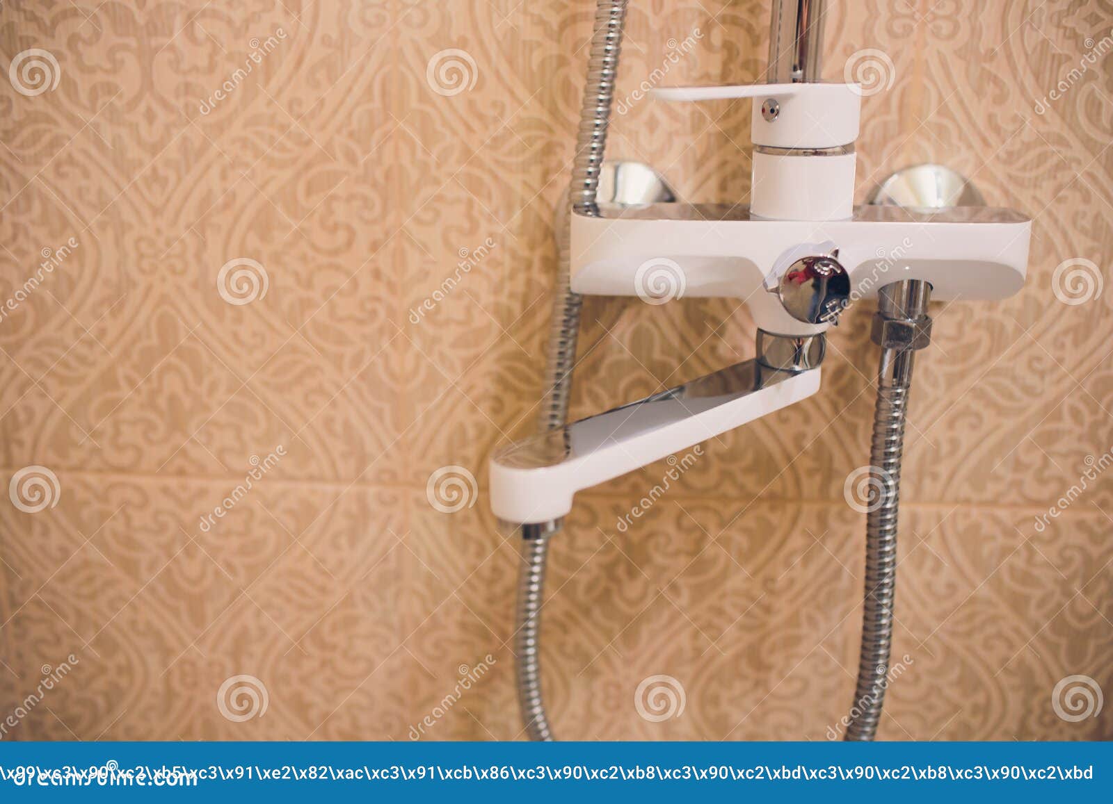 In the Bathroom, Open Shower Mixer Has Attached To the Wall Bracket