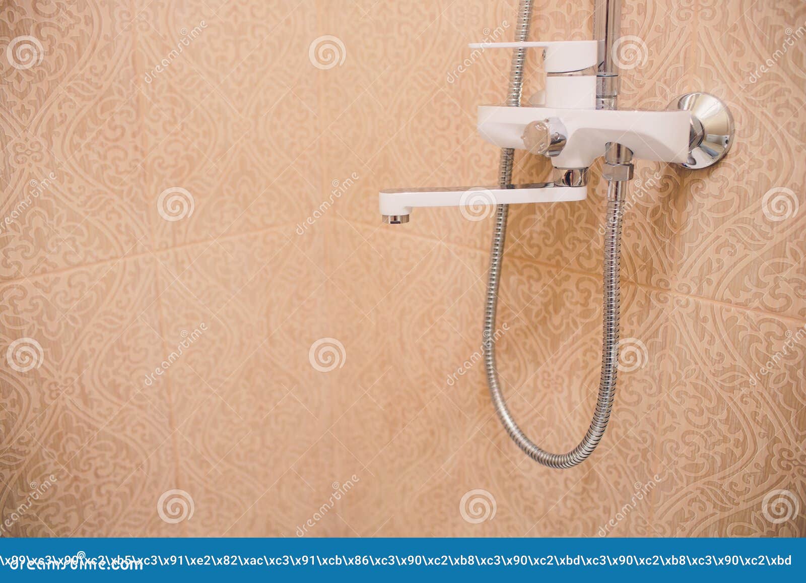 In the Bathroom, Open Shower Mixer Has Attached To the Wall Bracket