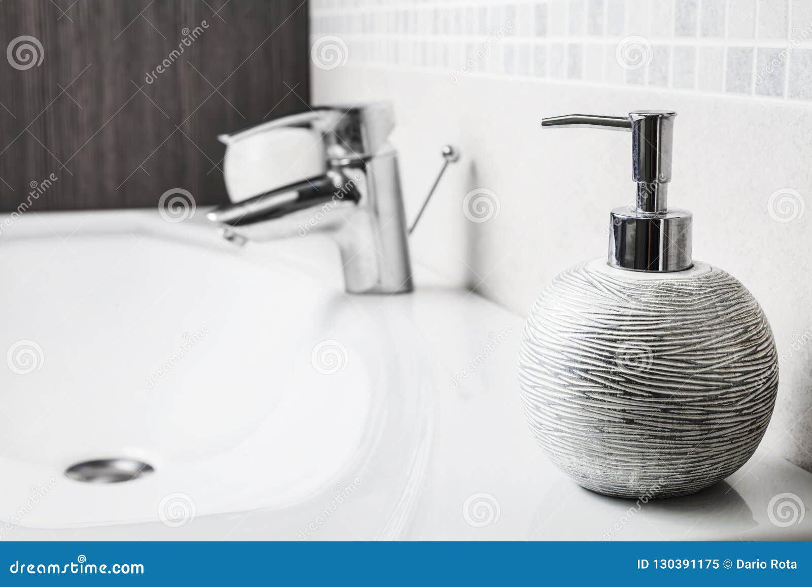 bathroom soap dispenser above sink