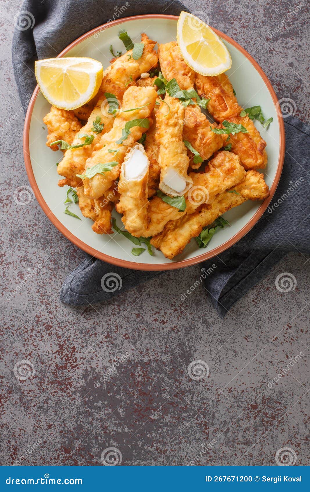 Battered and Fried Golden Squid Strips with Lemon Closeup on the Plate. Vertical Top View Stock ...