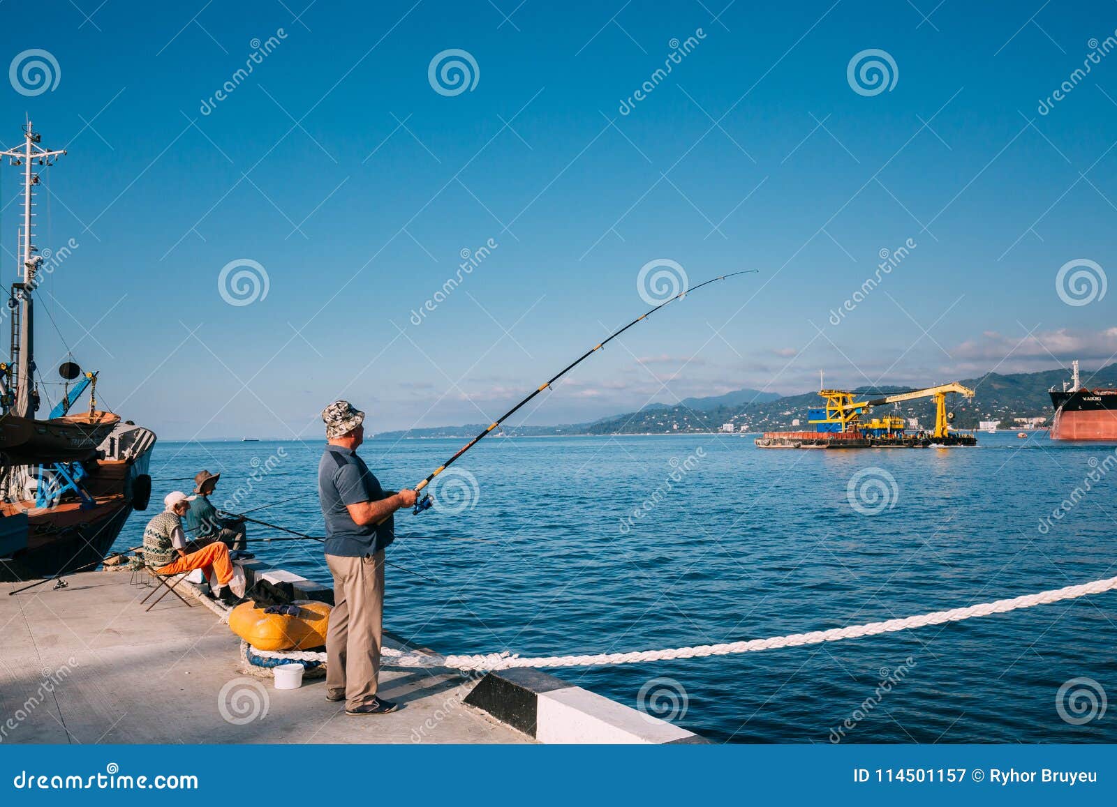Batumi, Adjara, Georgia. Old Man Fishing Near Port Dock On Sunny Editorial Photography - Image ...