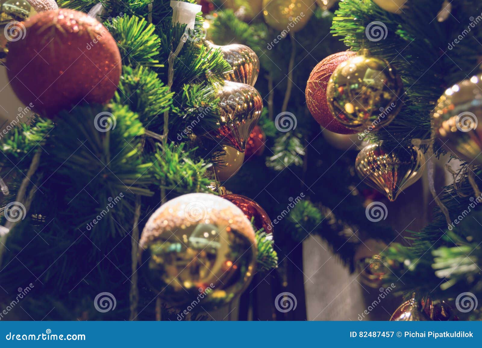 Bauble Hanging from a Decorated Christmas Tree. Stock Image - Image of ...