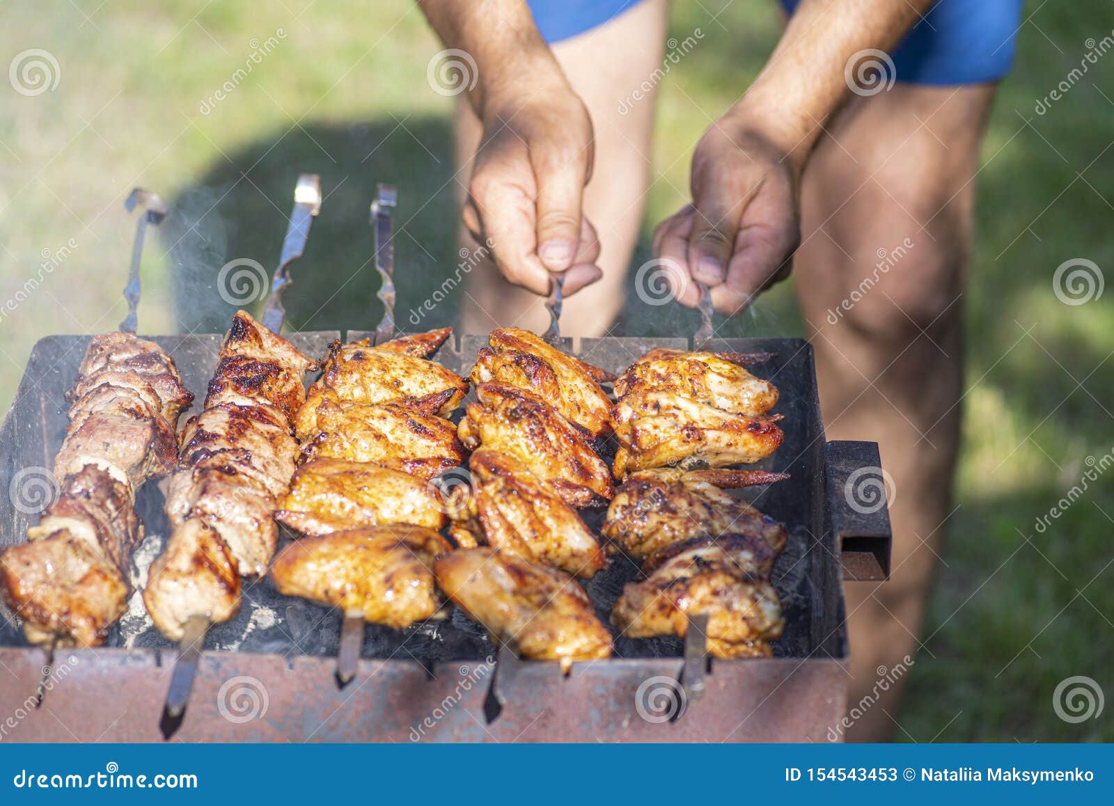 BBQ Chicken Wings in  Man Twirls Chicken Wings on Skewers Over  Mongal. Kebab Time. Fried Chicken  Stock Image - Image of  meal, sauces: 154543453