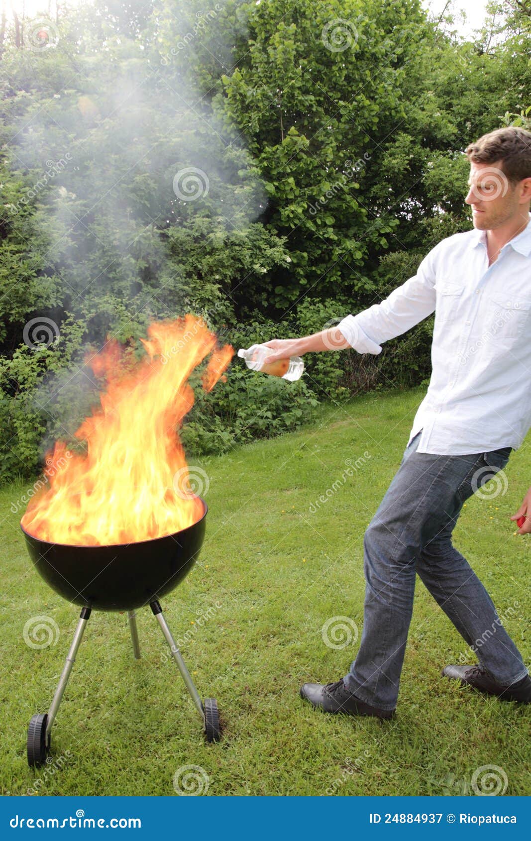 BBQ with fire an young man stock image. Image of garden 24884937