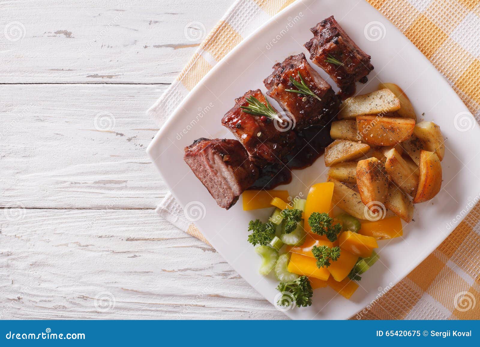BBQ Pork Ribs with Vegetables on a Plate. Horizontal Top View Stock