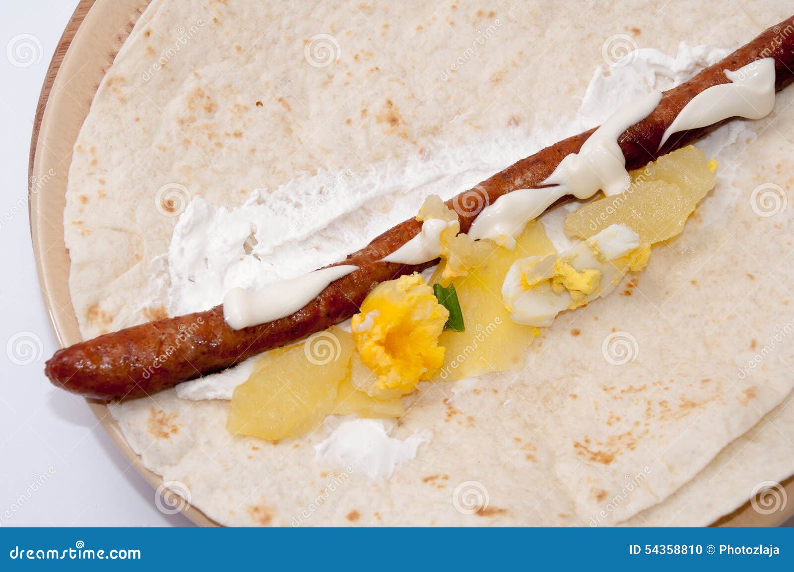 BBQ Sausage with Potato Salad and Eggs on a Tortilla Stock Photo