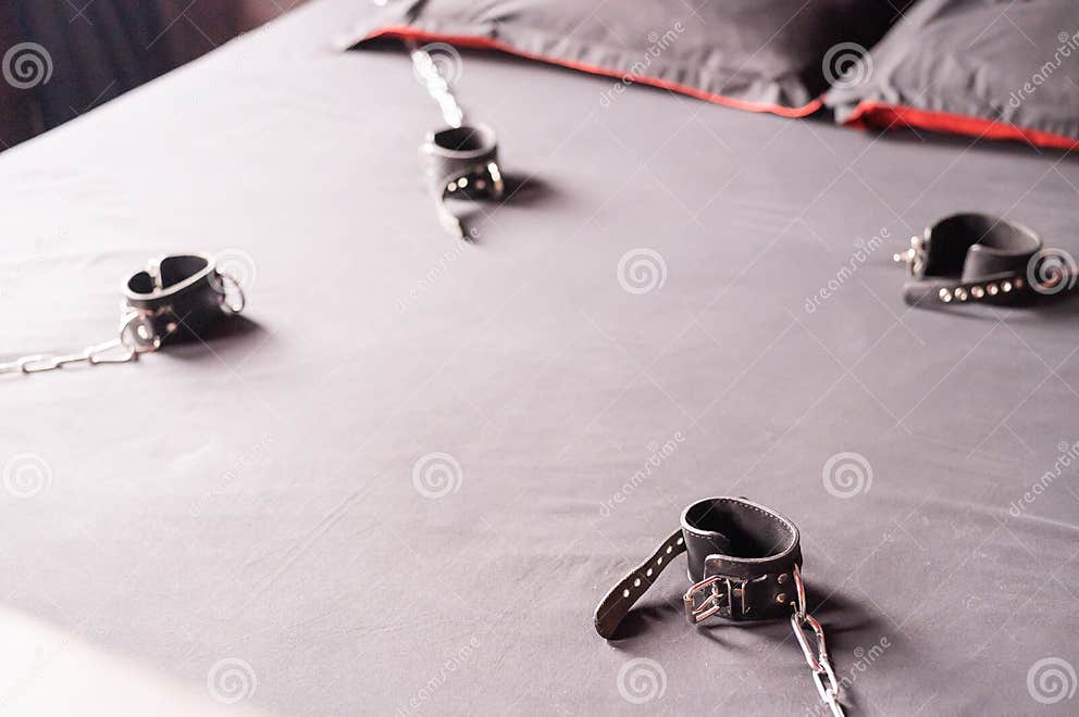 Bdsm Leather Handcuffs For Role Playing Games On A Gray Sheet Bondage For Carnal Pleasures