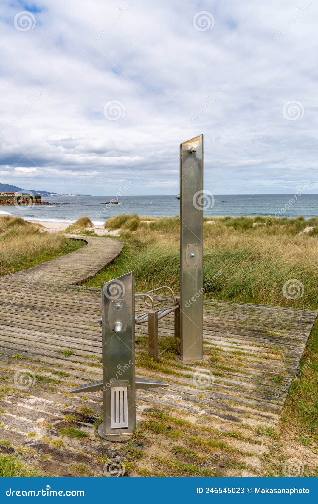 beach access with shower and wooden boardwalk on the coast of galicia