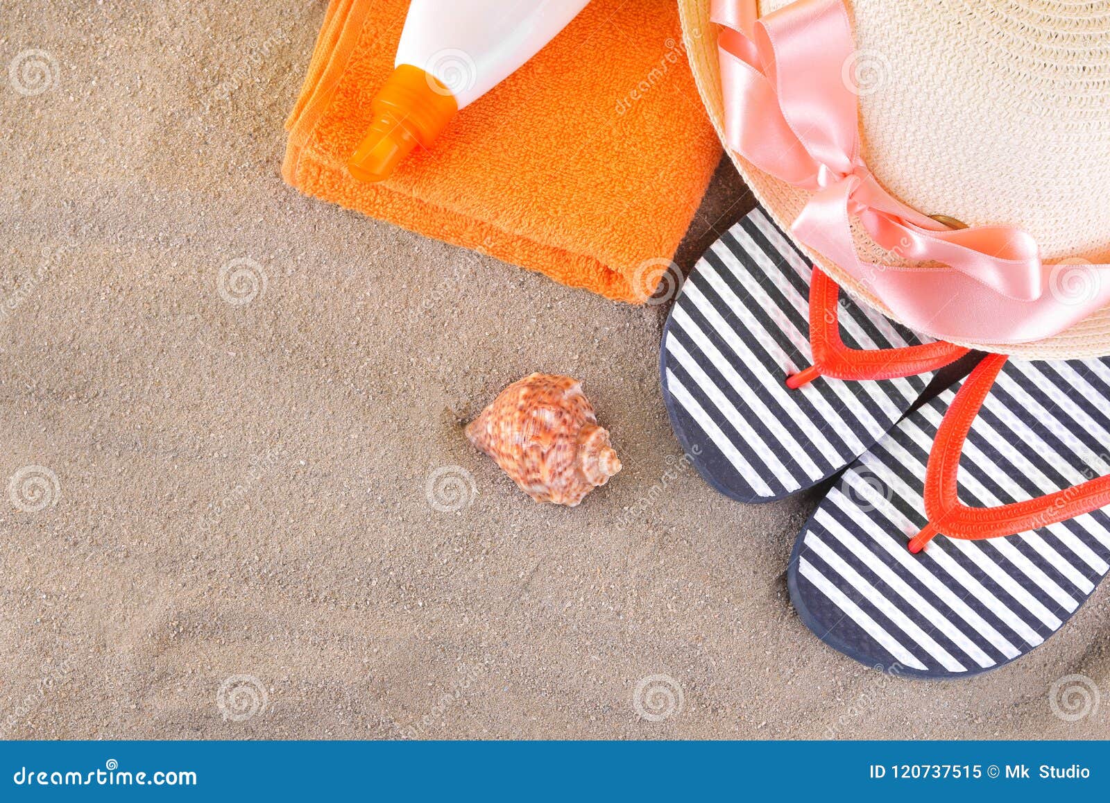Beach Accessories. Flip-flops, a Hat and a Sunscreen on an Orange Towel ...