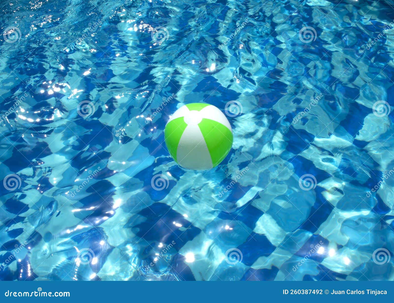 Beach ball in blue pool stock photo. Image of summer 260387492
