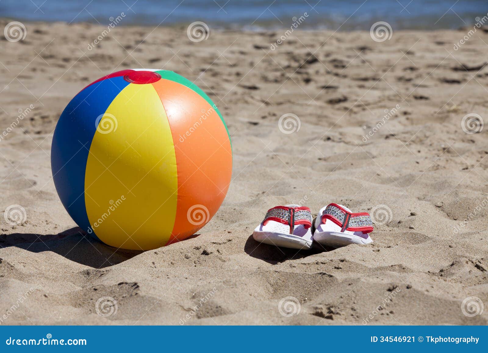 Beach Ball and Flip-Flops in the Sand Stock Image - Image of seawater