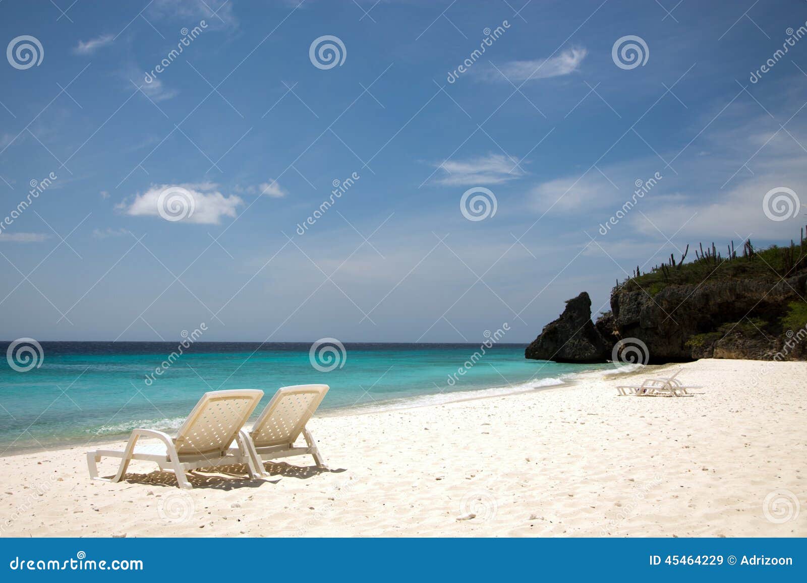 beach chairs and an azure blue sea