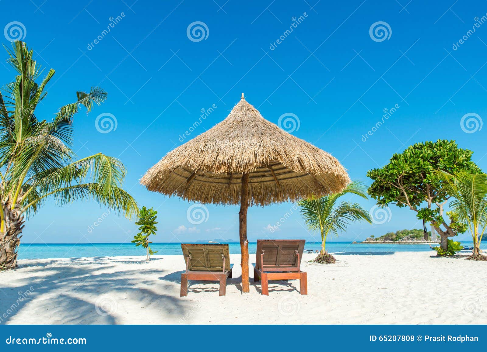 beach chairs and umbrella on island in phuket, thailand