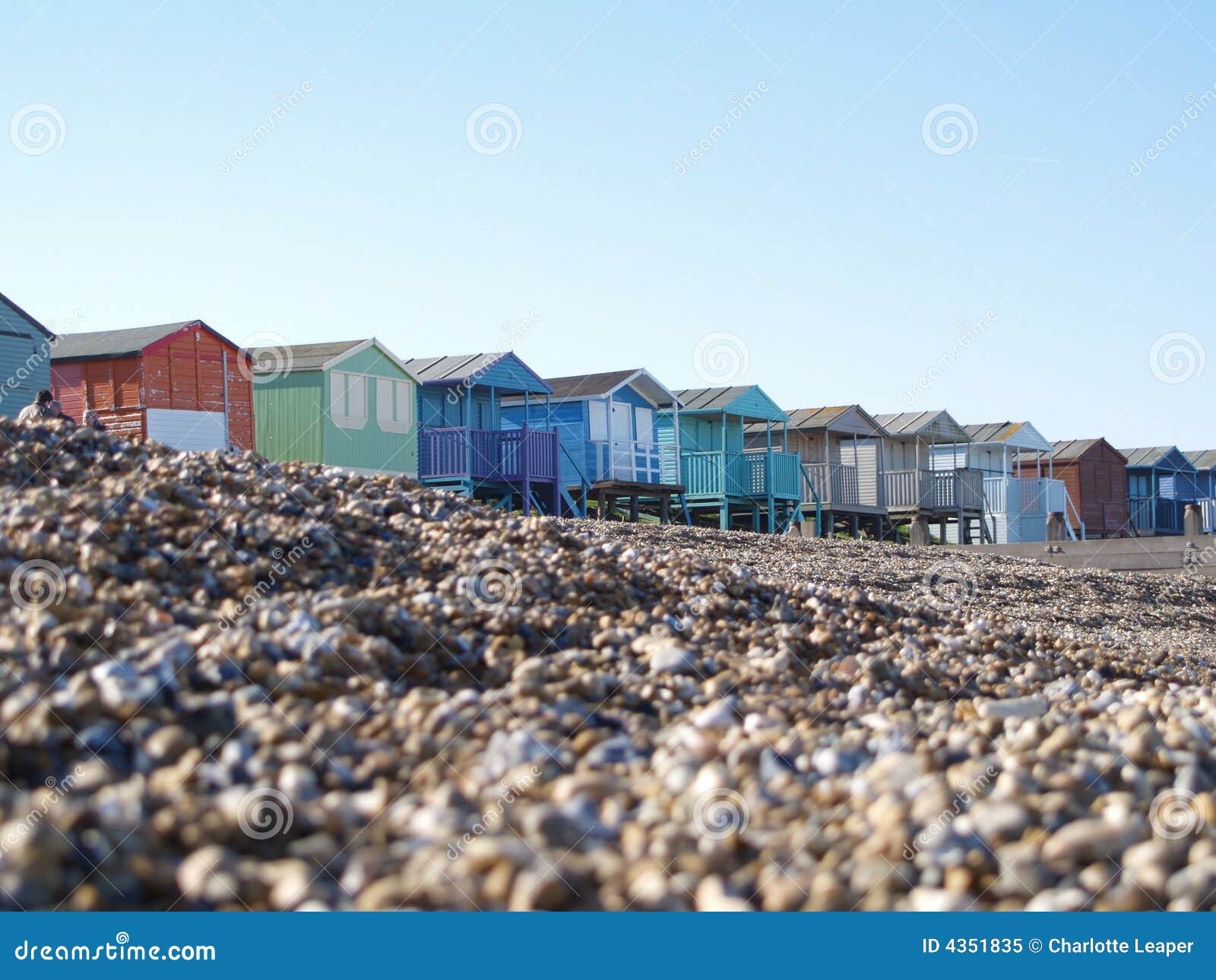 beach huts on pebble beach