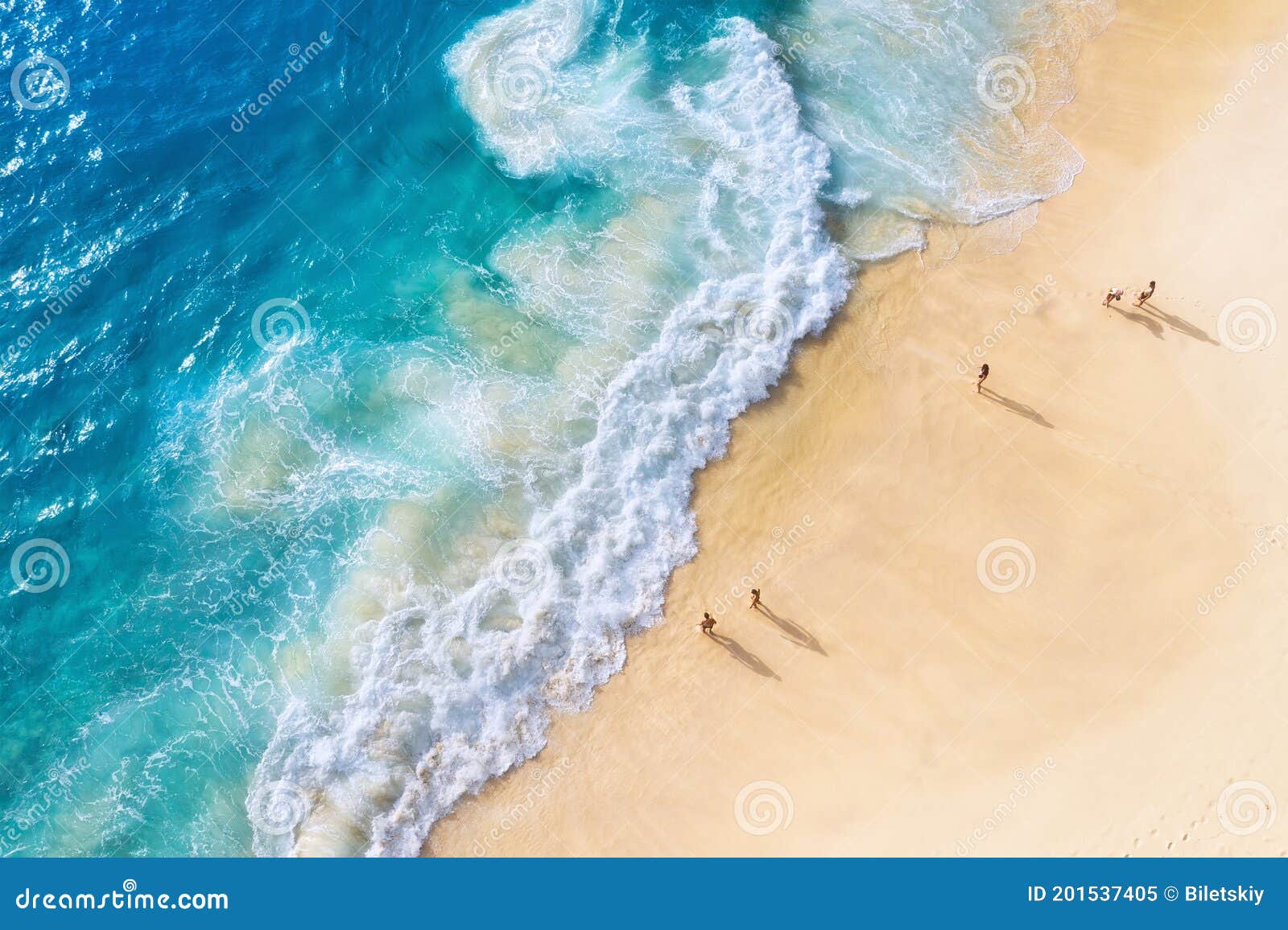 beach and large ocean waves. coast as a background from top view. blue water background from drone. summer seascape from air.
