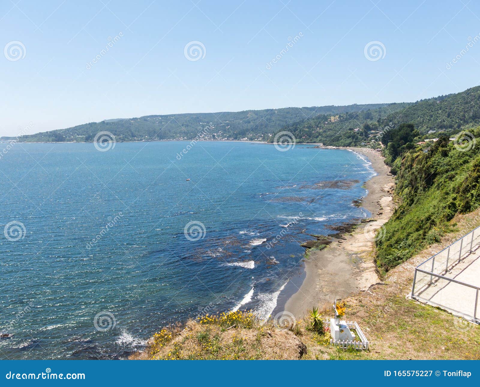 beach lovers facing the pacific ocean from the fort of niebla village. estuary and mouth of the valdivia river. valdivia, los rios